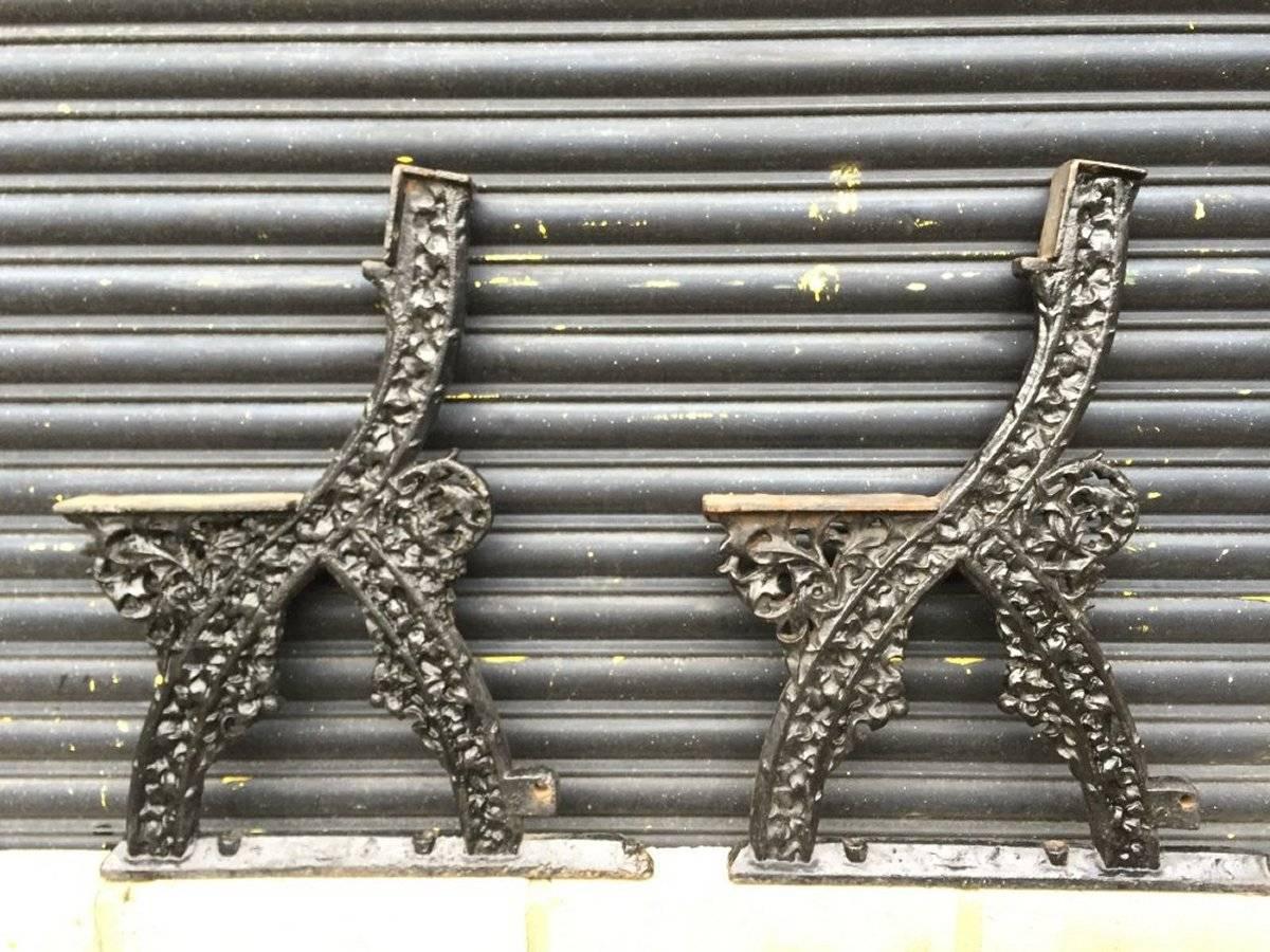 A rare pair of early Gothic Revival cast iron garden bench ends designed by A.W.N. Pugin with foliage details which is slightly obscured at the moment due to the many coats of paint. The first image here with wooden seat and back is an example of