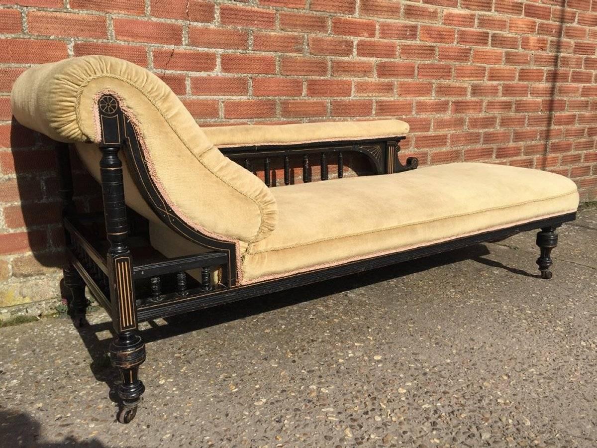 A good quality Aesthetic movement ebonised and parcel-gilt chaise longue, with nice fluid understated detailing in the style of Collinson and Lock.