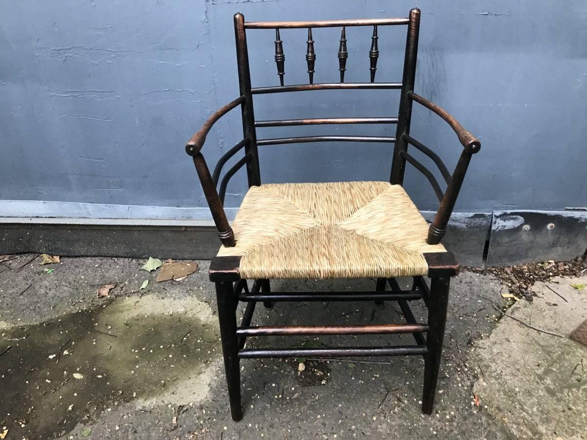 William Morris,  A classic Sussex Arts & Crafts ebonised armchair from the Sussex range.
Fully restored with a new rush seat. 
We have been restoring Sussex armchairs for over 30 years and to be fully restored correctly with a new rush seat, we