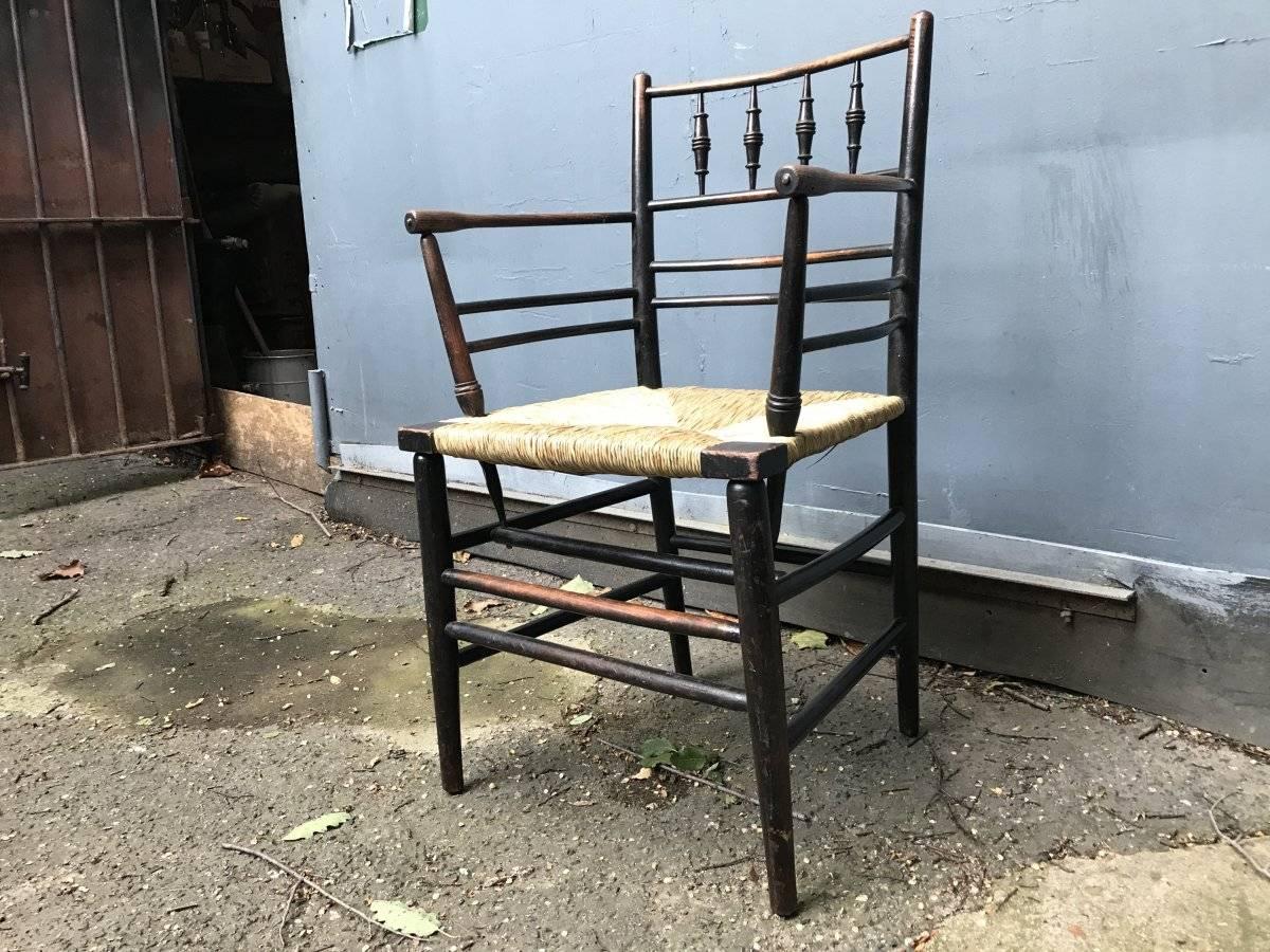 William Morris:: A Classic Arts & Crafts Ebonised Armchair from the Sussex Range. (Englisch)