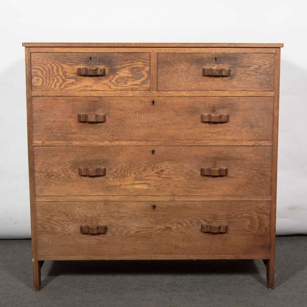 An Arts & Crafts Cotswold school oak chests of drawers in the style of Edward Barnsley with handmade walnut handles and exposed through tenon construction to the sides.