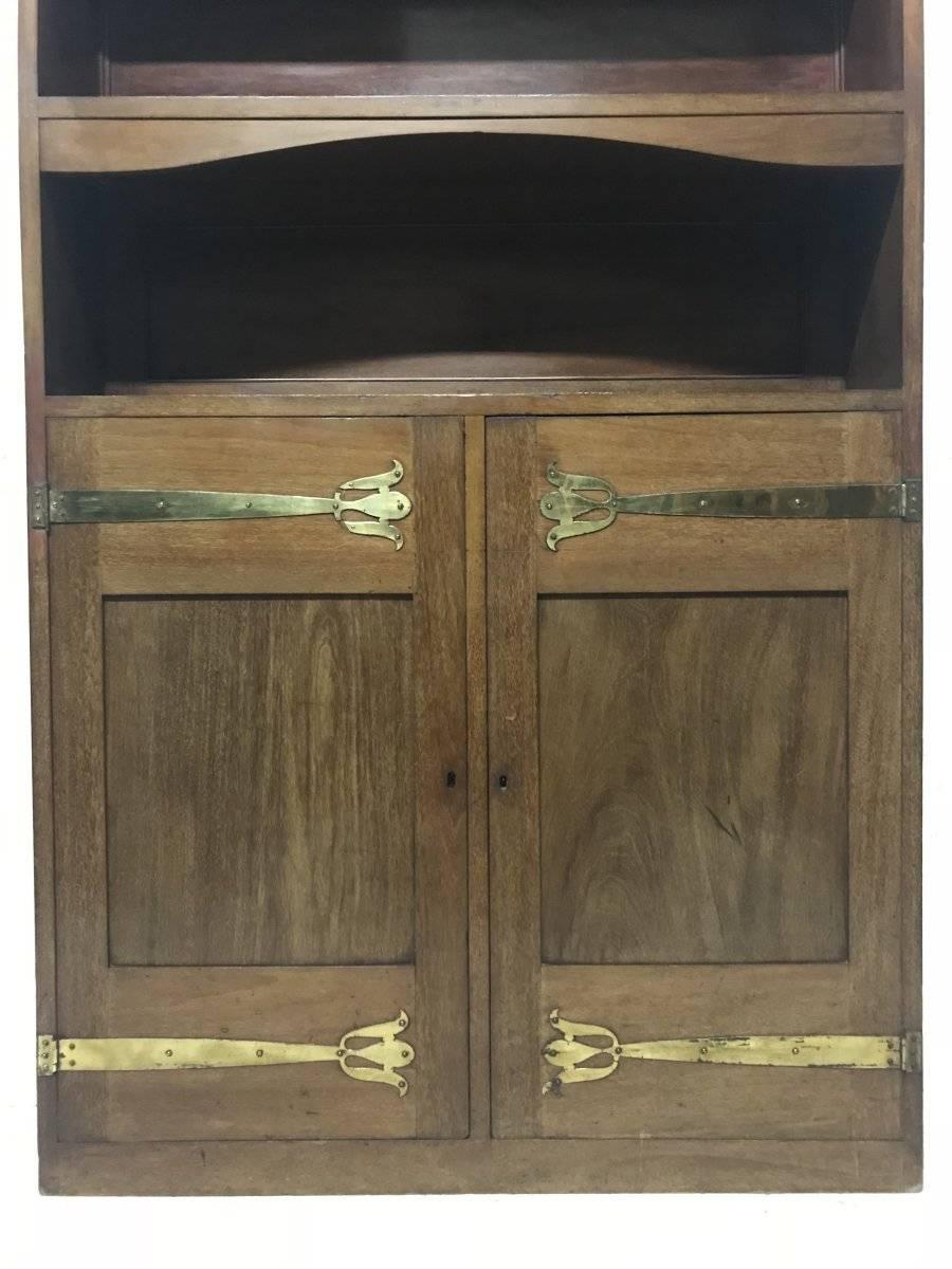 Arts and Crafts Liberty & Co. A Slim Arts & Crafts Walnut Bookcase with Stylised Copper Hinges For Sale