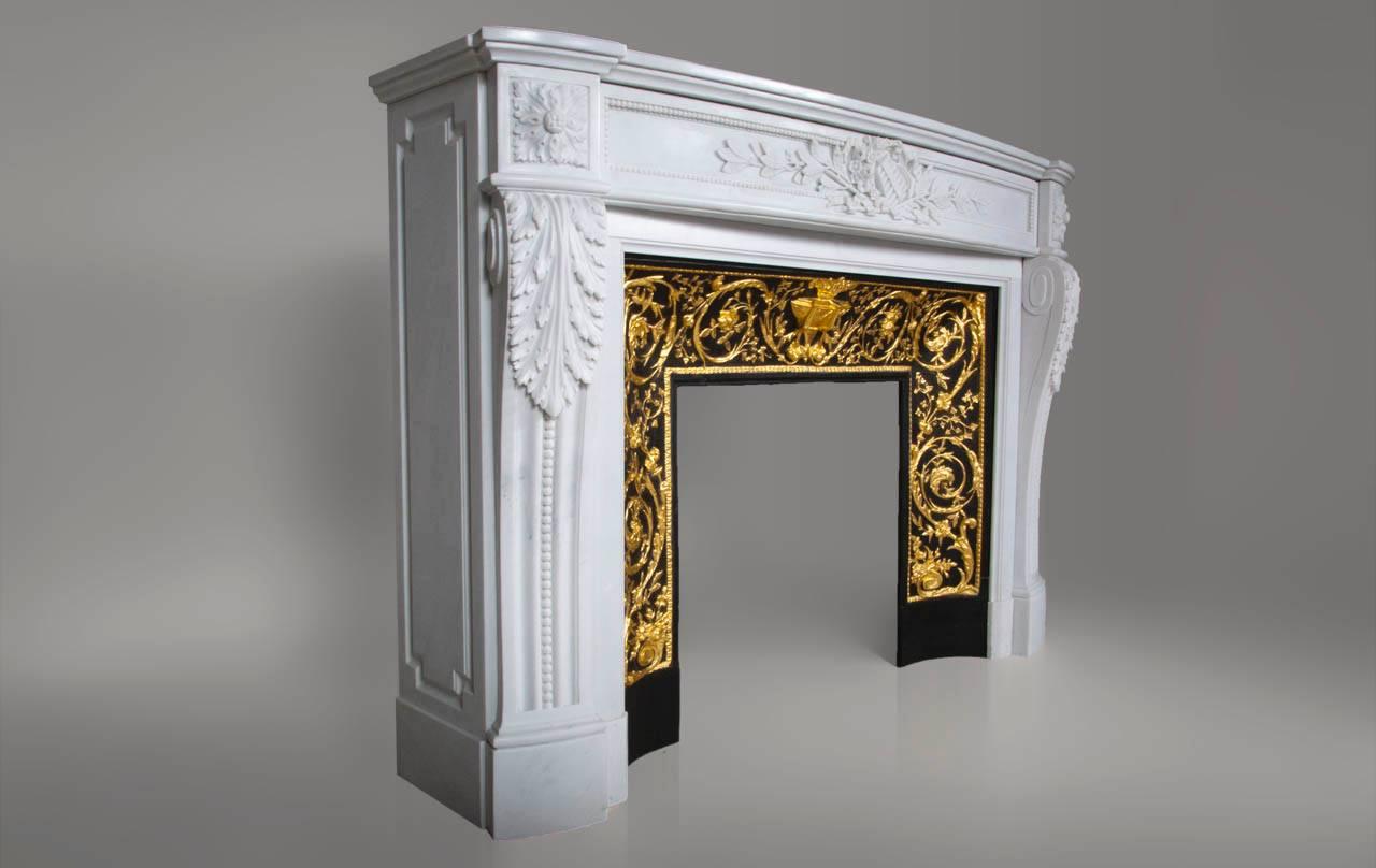 This fireplace, manufactured in our workshop, is culpted out white Carrara marble with a unique carved decor. 

The curved architrave is decorated with a plan flute and vegetal. The jambs are decorated with windings on their upper part and