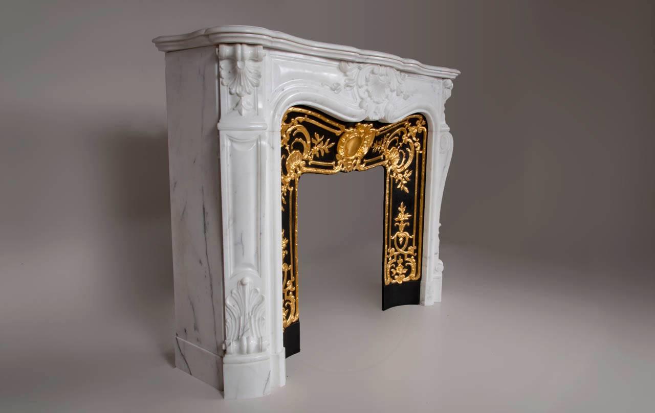 “Madame Du Barry” is a Louis XV style Carrara marble fireplace with an opulence decoration.

The highly curved shape is decorated with finely carved flower motifs. The center of the front is decorated with a large floral shell, a motif that we