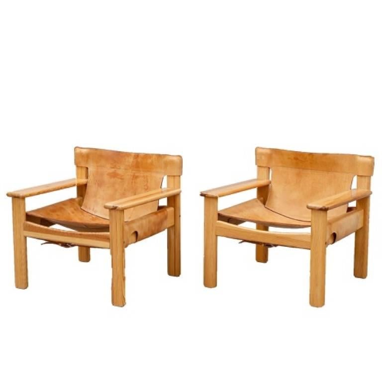 Bold and comfortable Danish modern armchairs by Karin Mobring, Sweden, designed in 1977, oversized pine frame with thick natural leather, with incredible patina.