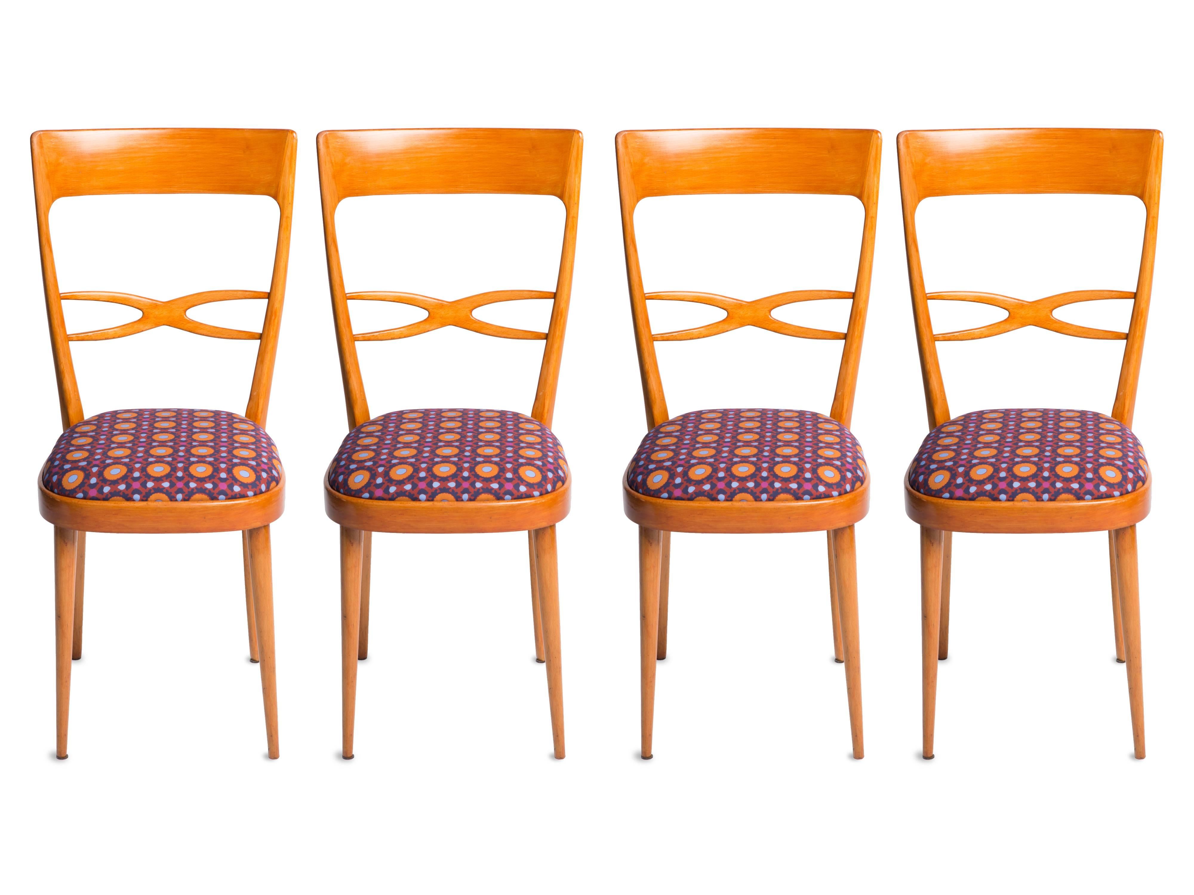 Set of six 1950s Italian chairs in the style of Melchiorre Bega, featuring varnished birch wood and newly upholstered seats. All six chairs were sourced in Milan by LaDoubleJ: two chairs feature the brand’s re-issued vintage Tulipani fabric, while