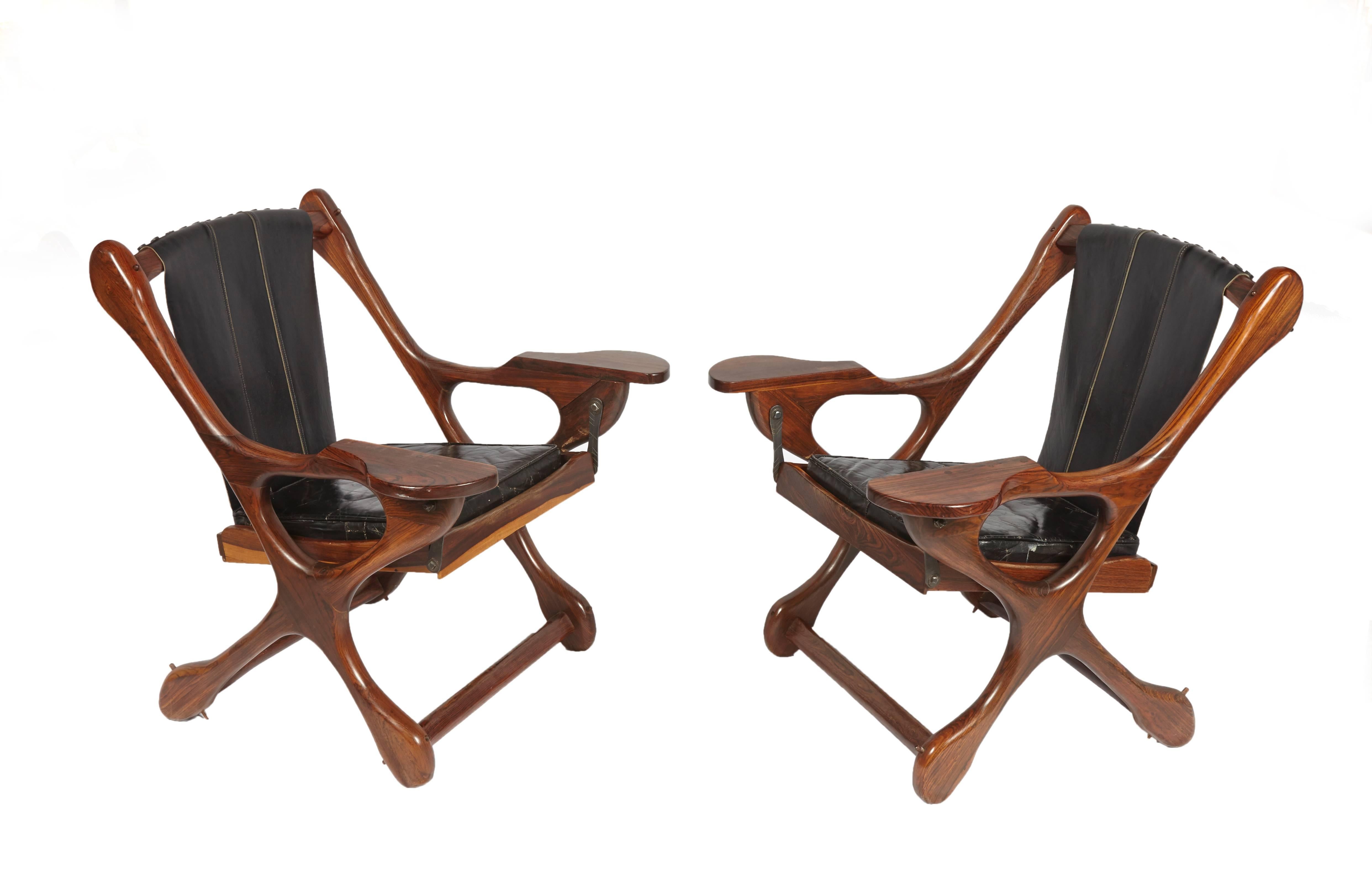 Pair of Don S. Shoemaker Sling swinger chairs with matching ottoman made of cocobolo wood. Original black leather.
Chairs and footstool have the Senal, S.A. stickers.
 