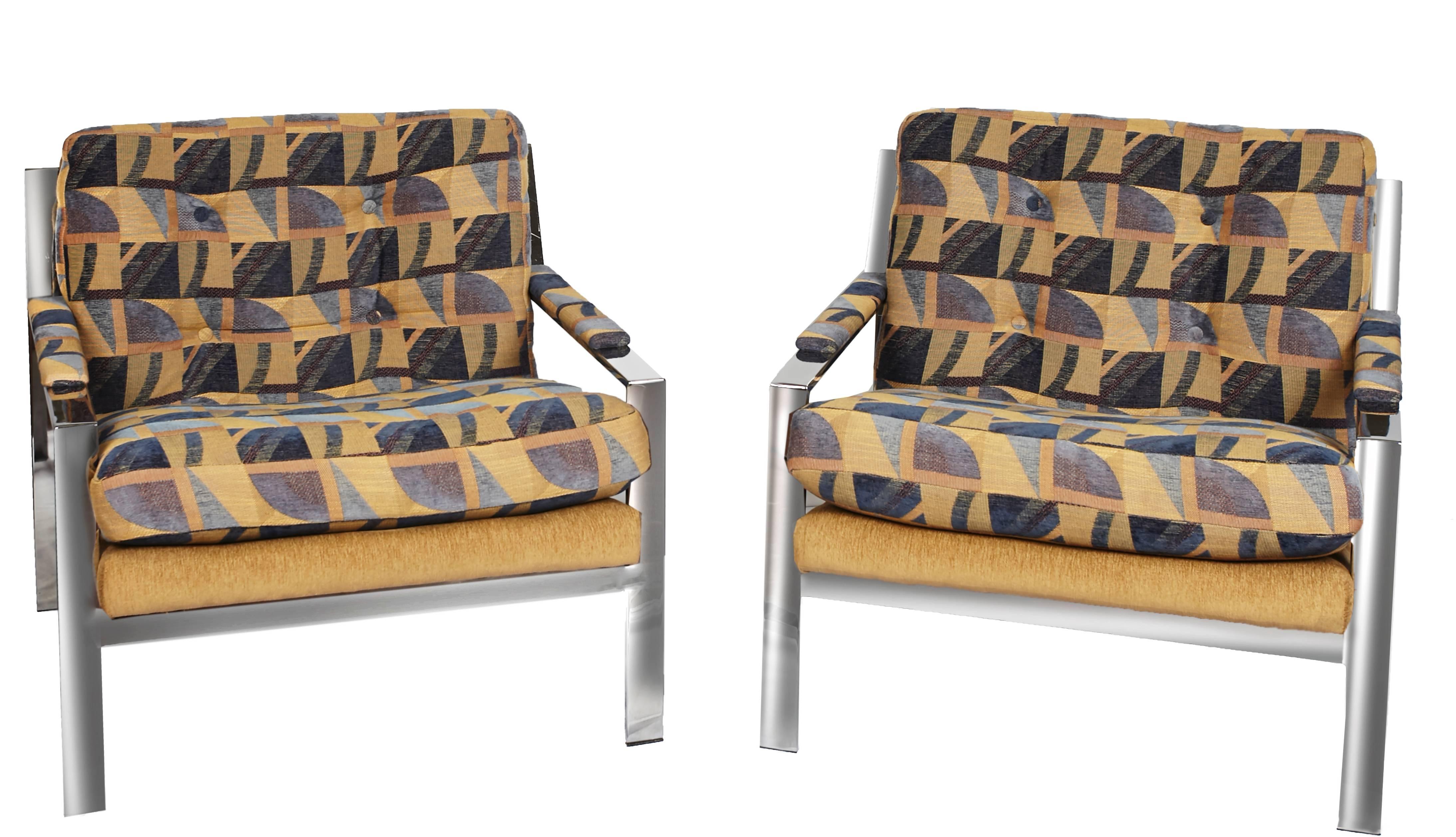 Pair of Cy Mann lounge chairs from the 1970s, with polished chrome and original fabric. It is model #232, a flat-bar design in polished chrome.
A blue tan and black fabric with geometric design. The back and seat cushions are semi-attached and arms