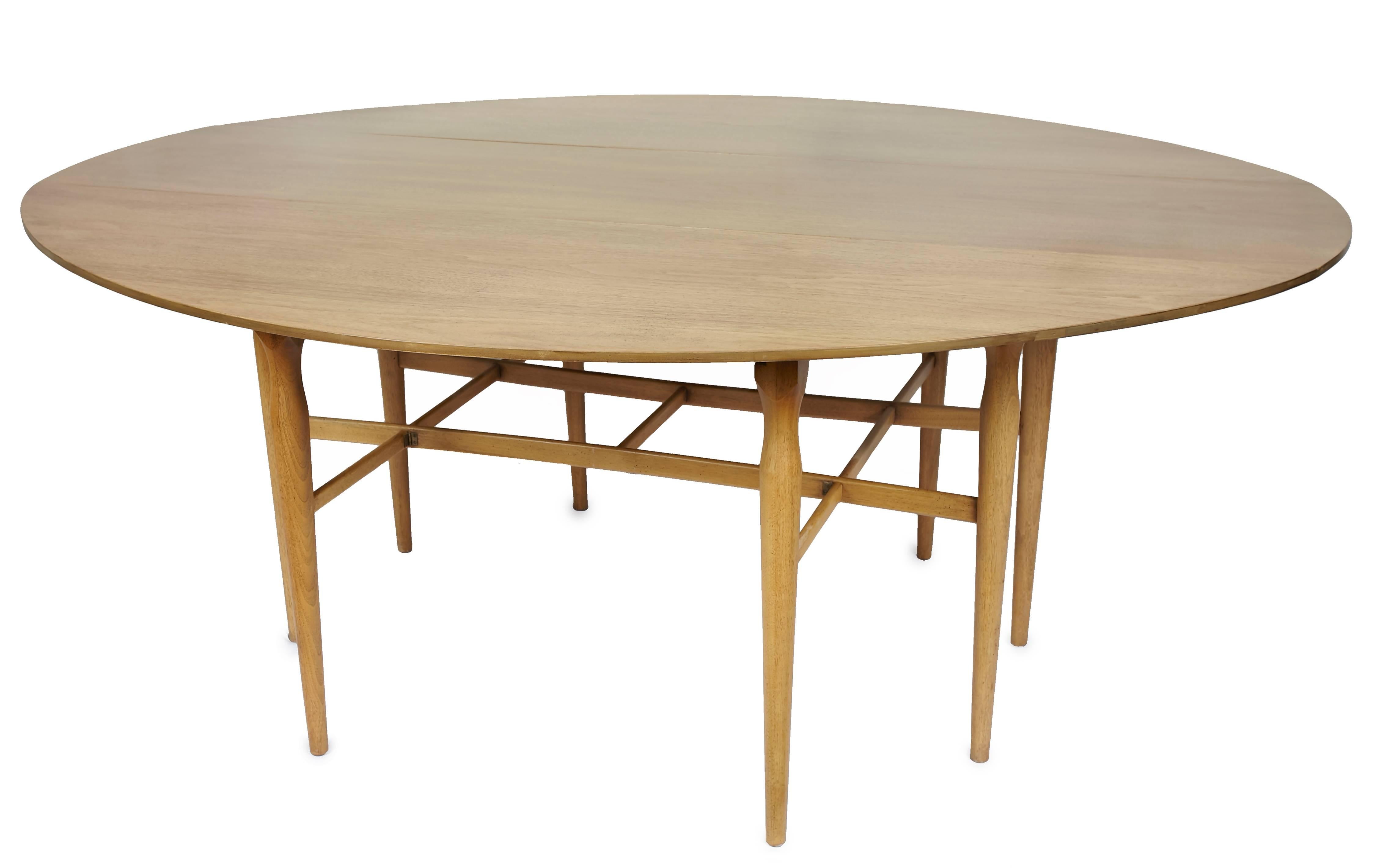 Restored Heretage Henredon gateleg table.
Top measures 19.5 inches deep when sides are down. When sides are up the table measures 72 inches wide and 60 inches long.
Eight tapered legs.