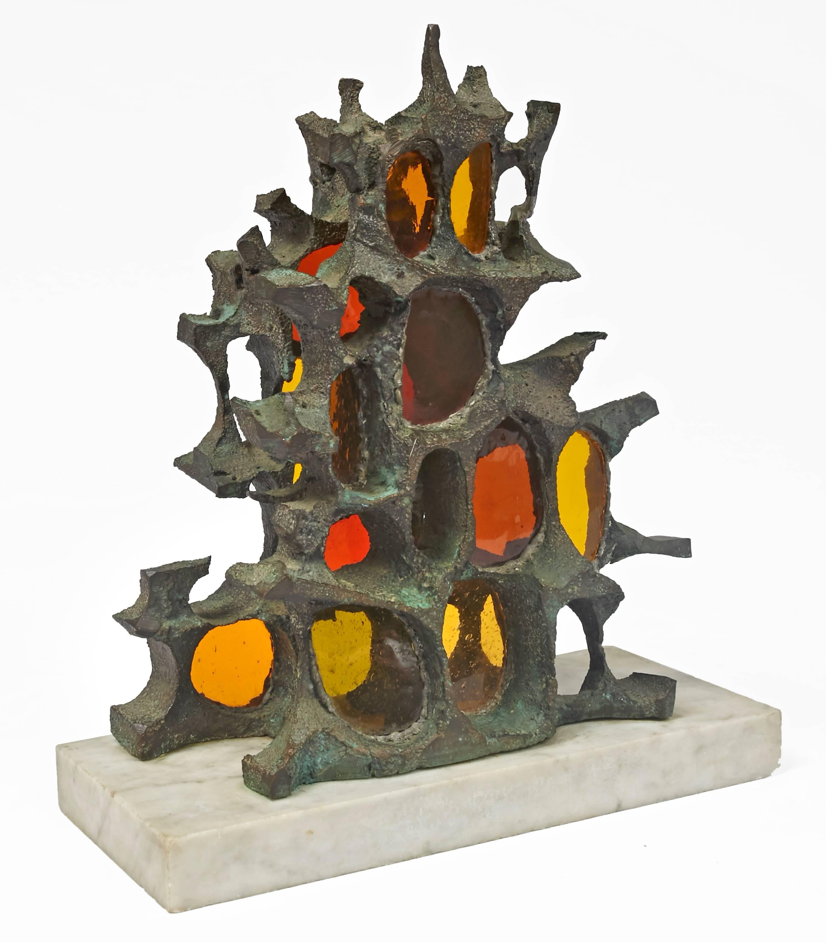 Patinated bronze Brutalist sculpture with colored glass inserts, mounted on carrara marble base.