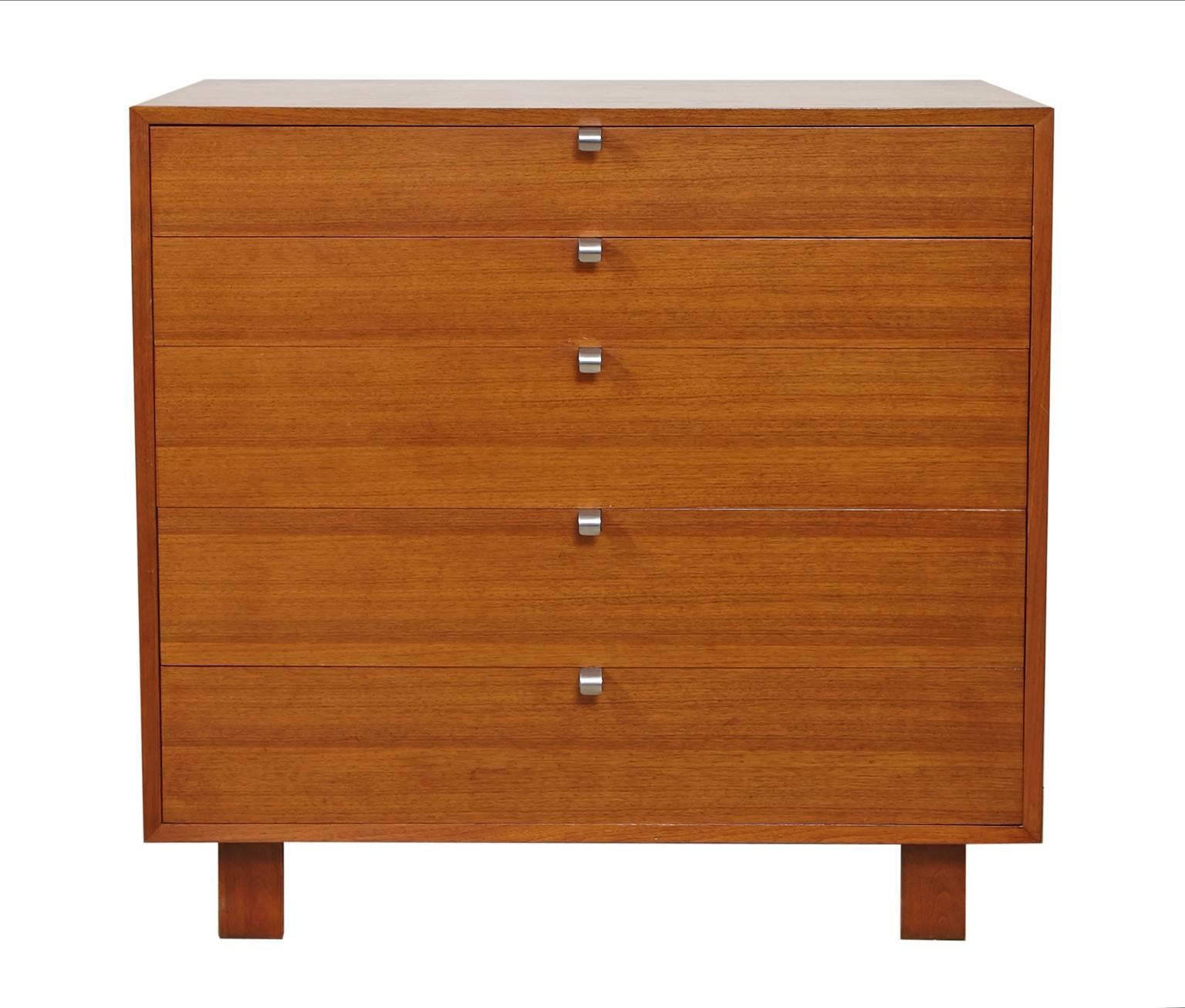 George Nelson for Herman Miller five-drawer, chest of drawers in walnut with original metal pulls. The upper drawer has dividers with the foil label bearing the George Nelson-Herman Miller name. Lower drawer also has dividers.
    
    
   