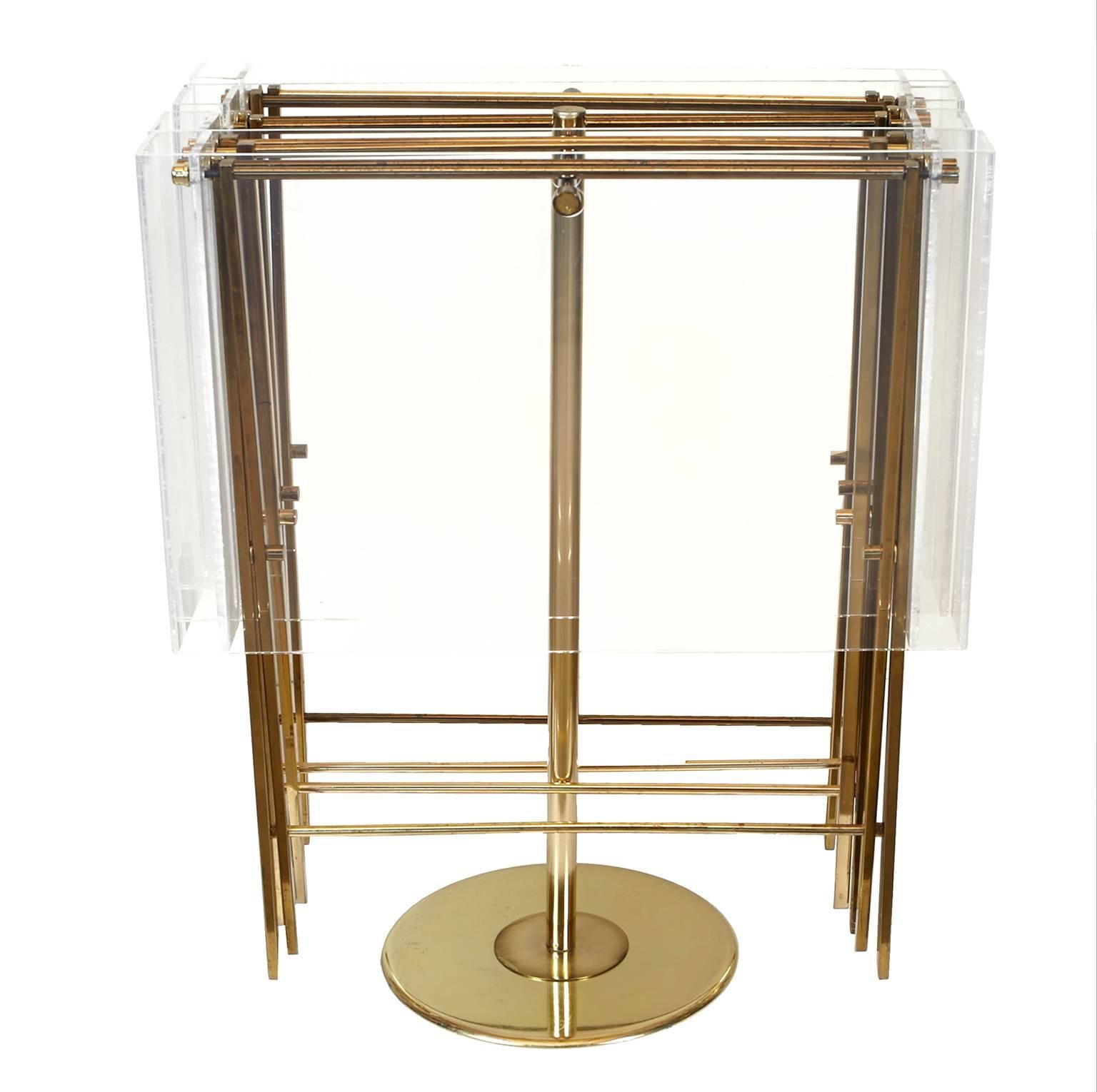 Set of Lucite and brass serving trays on brass stand. These trays have a beautiful profile when opened.
Measurements of trays out of stand are 23 inches wide, 16 inches deep and 24.5 inches high. Measurement in stand are below.
   