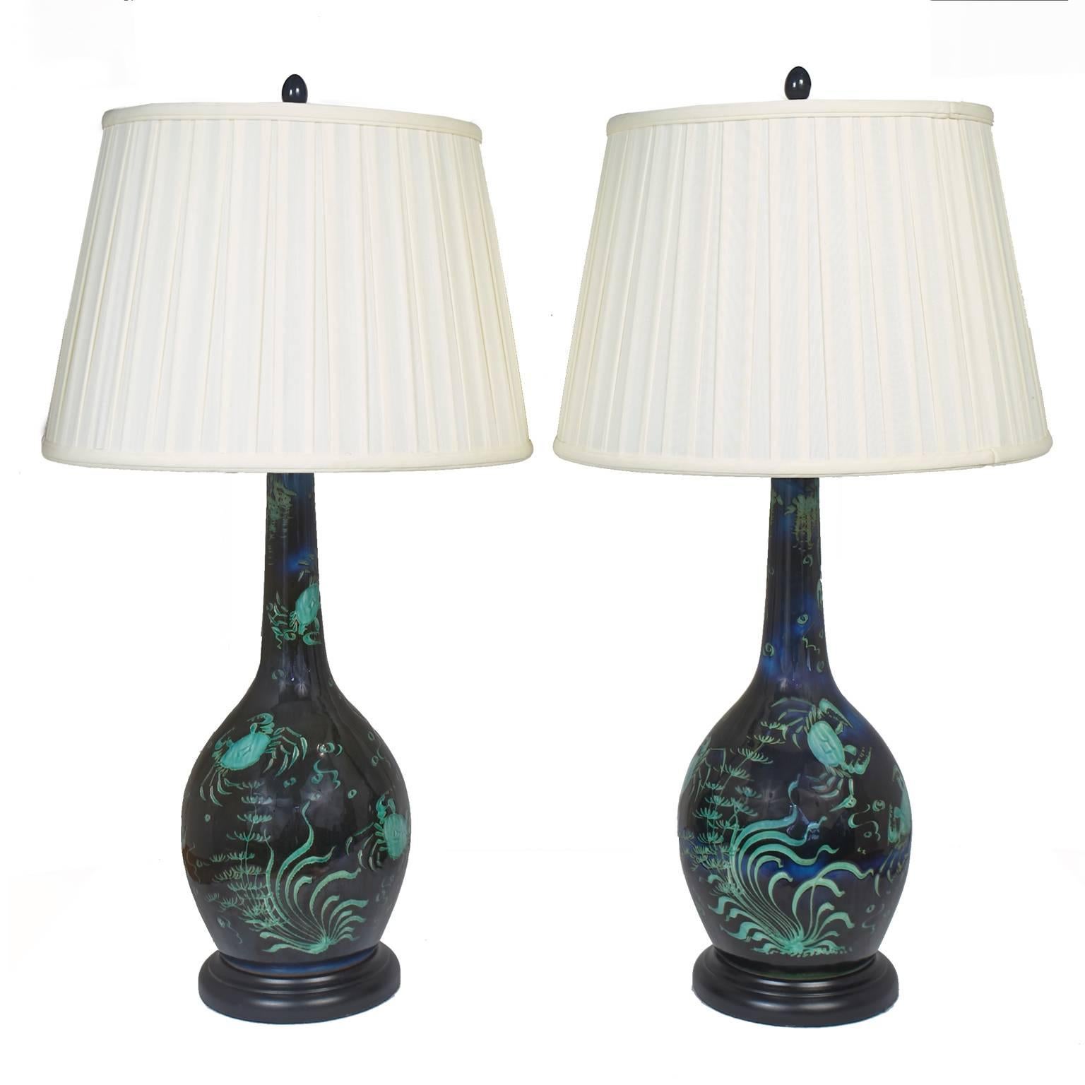 Beautiful ceramic lamps. Deep blue with black. Turquoise green crabs with Turquoise Ocean plants.
New wiring and shades.