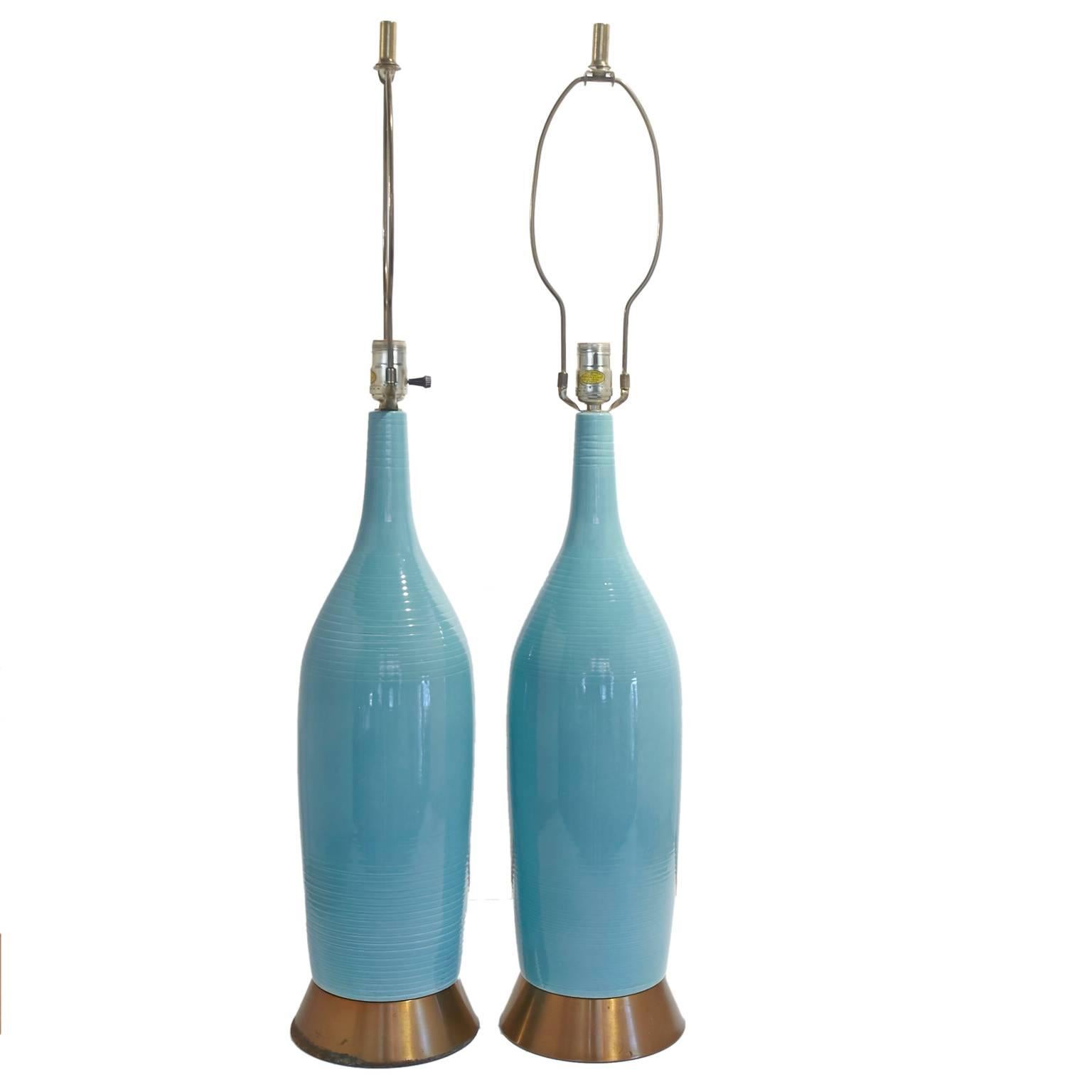 Great pair of turquoise Mid-Century lamps with original shades. 
Brass base.