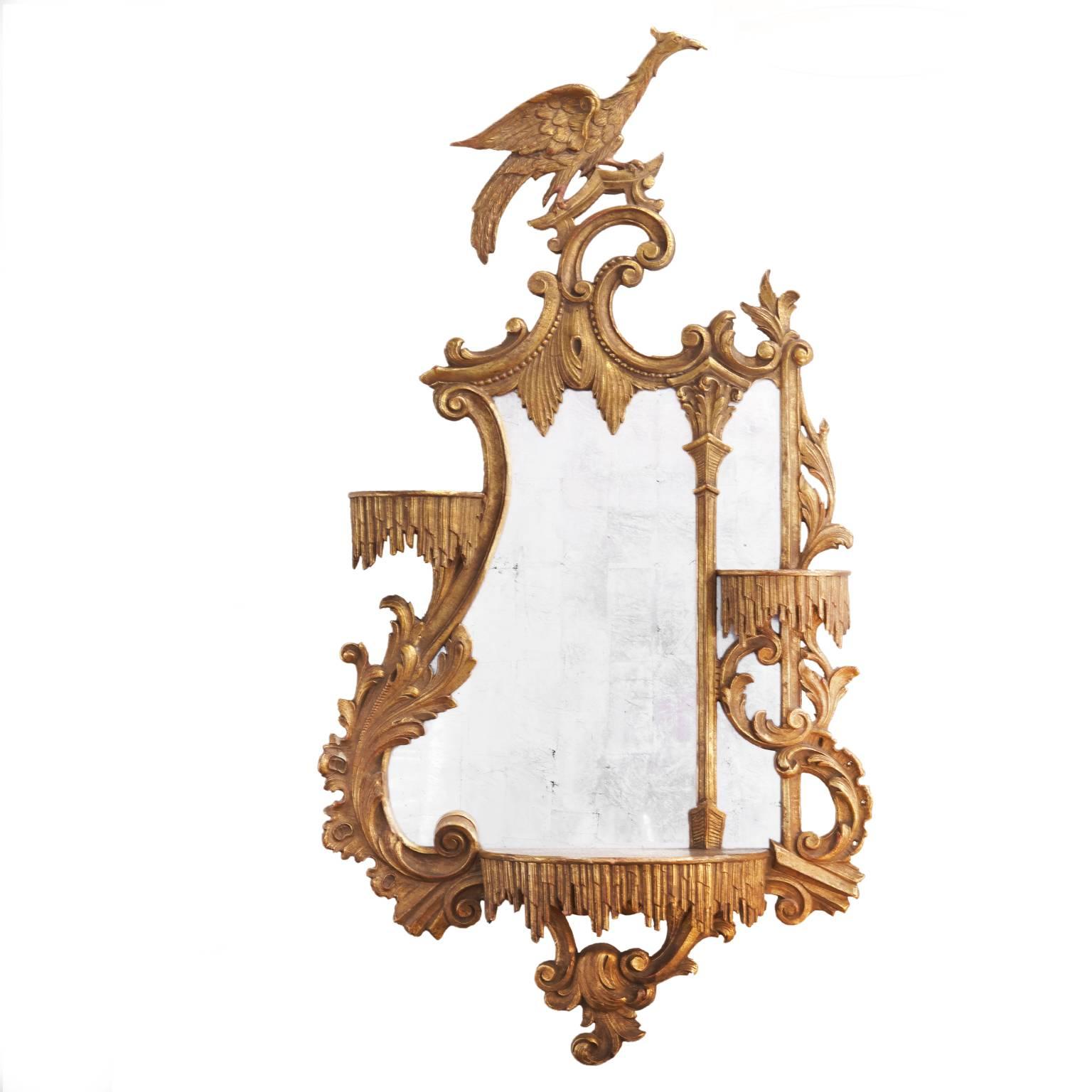 Beautiful pair of opposing giltwood carved eagle mirrors, 20th century, 
Chippendale style mirrors with three shelves on each mirror, eagle perched at the top of mirror.