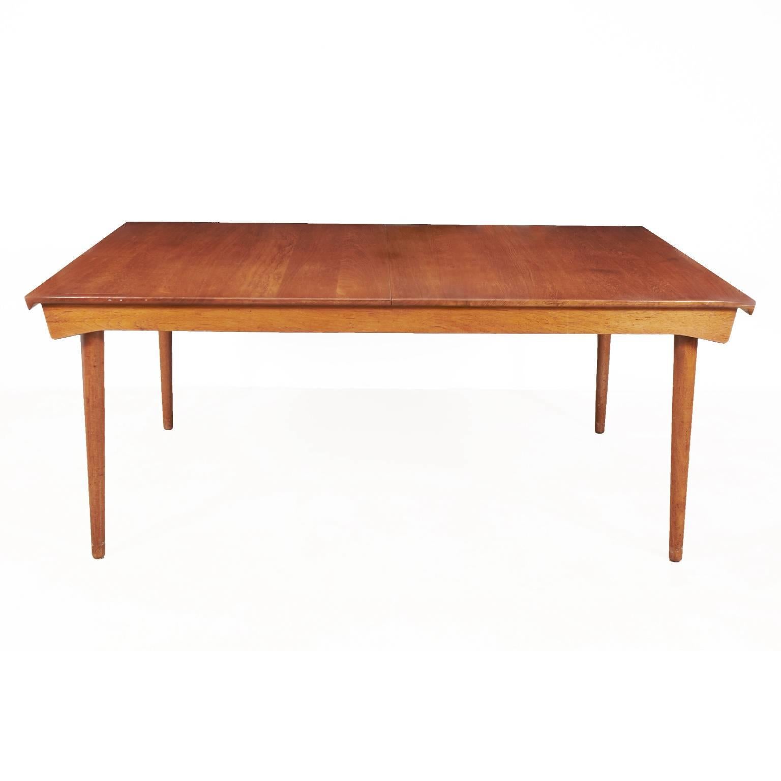 Beautiful solid teak Finn Juhl model FD 540 dining table by France & Son imported by John Stuart, has round John Stuart label on underside of table.
The table has two self stored leaves which are hidden when table is closed. Table is 67 inches long