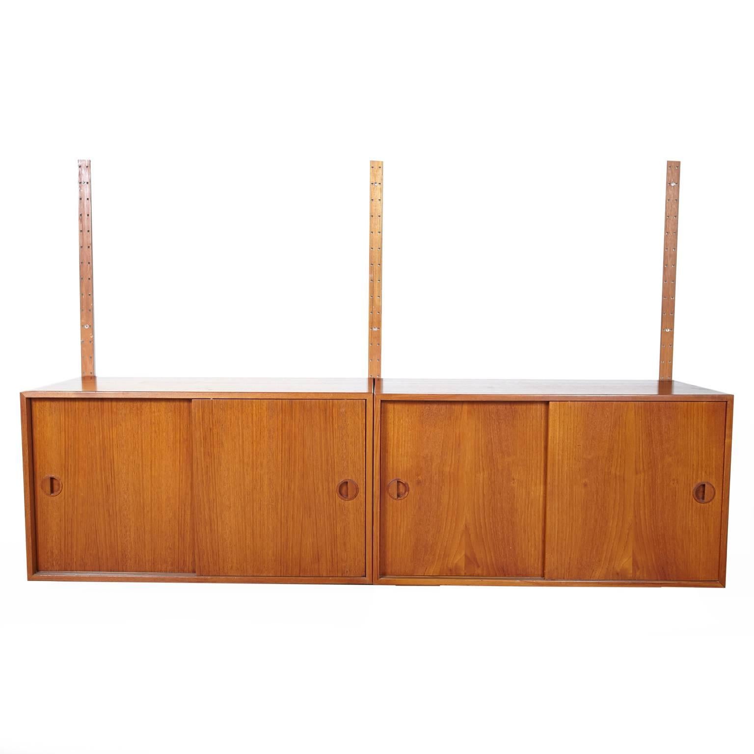 Attractive two-cabinet floating wall unit made by Hansen and Guldborg (HG Furniture), in Denmark. Stamped on back. Complete with three metal rails,
eight brackets, and screws for mounting. Measurements listed were for lower cabinet. Upper cabinet