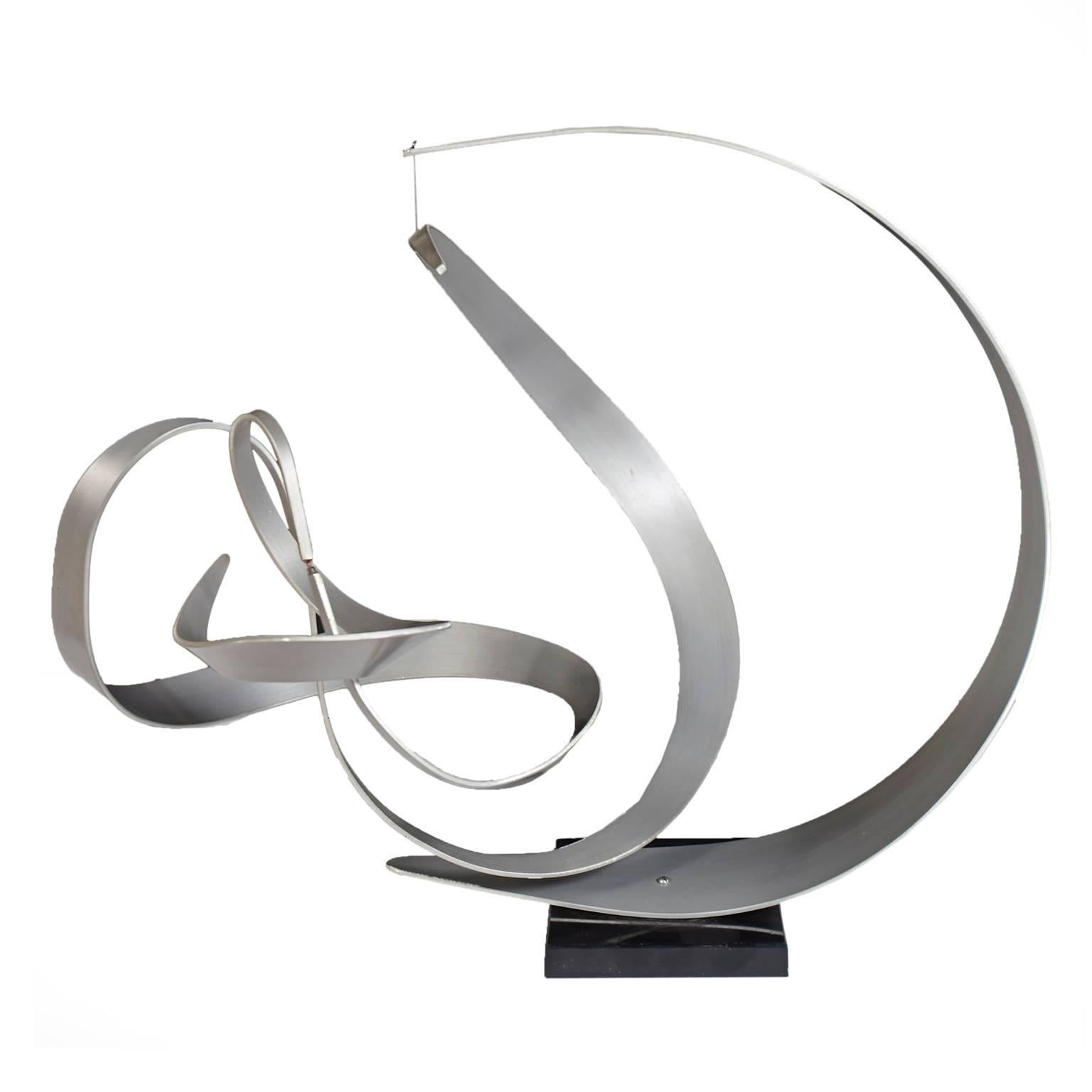An amazing work of art, elegant aluminum sculpture that moves at the slightest touch and remains perfectly balanced. Base has label marked, 