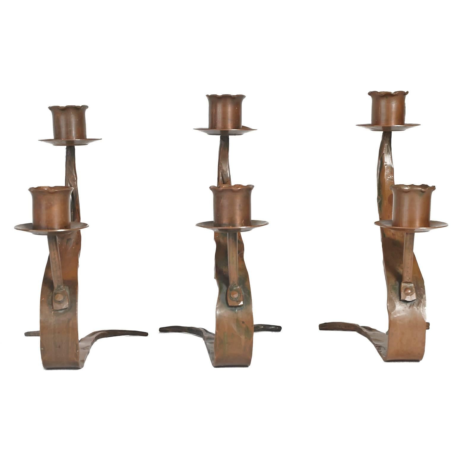 Three copper candleholders made by Erhard Glander. Marked G Hand Wrought on the bottom of each candleholder. Elegant, sculptural, stylized set.