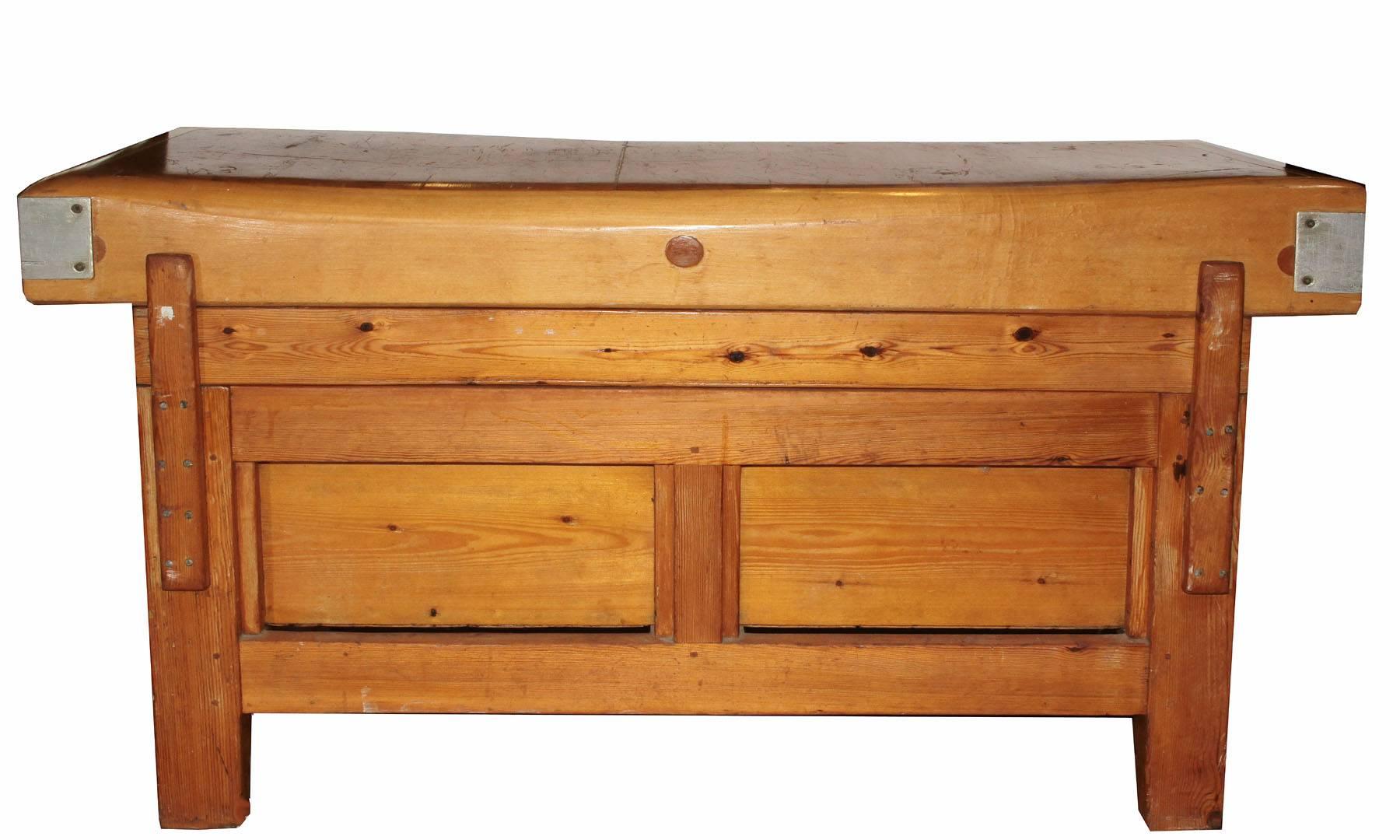 This is a solid maple top butchers block. The top has been finished but the details show through. Two drawers make it extra functional as well as a nice visual balance. The edges are accented and reinforced with metal trim.