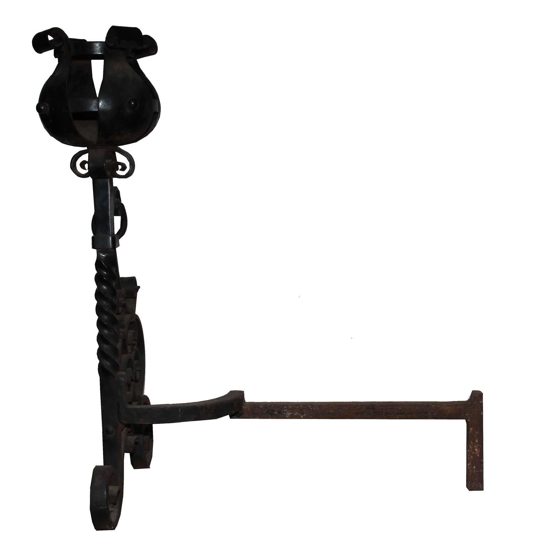 This is a pair of large rod iron andirons from the late 19th century. They are connected by a removable rod iron chain. The hand crafted iron work has amazing details. The scale is very impressive and the attention to detail is present throughout