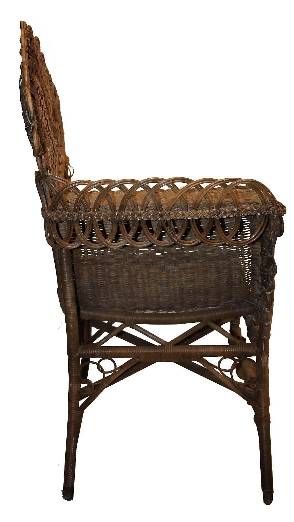 This chair was made to be used in a photo studio to have your picture done in the 19th century. Made of Wicker and cane it was created by the Heywood and Wakefield co. The details are amazing. Cane work flawless. It has a few condition issues that