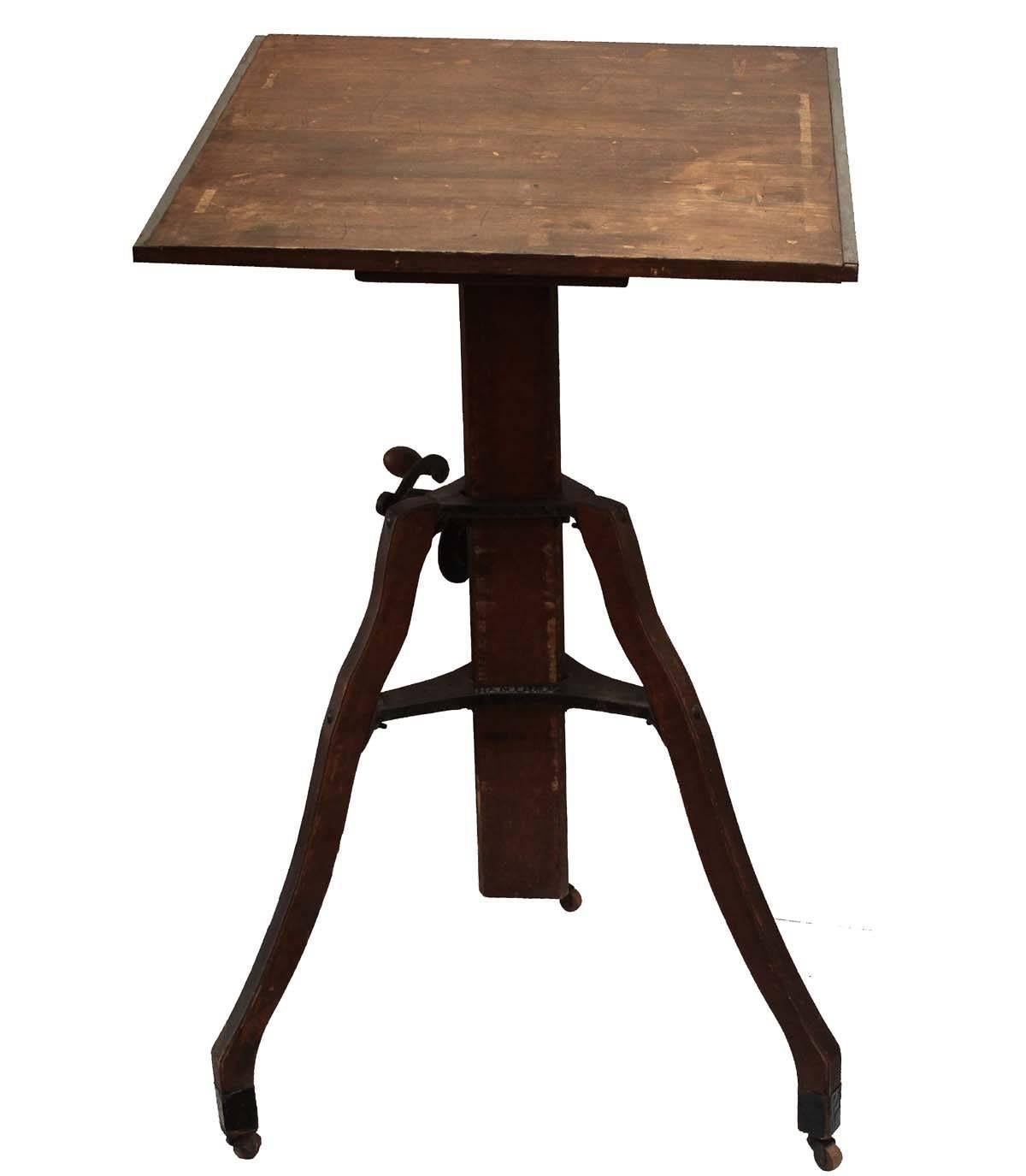 Early hand crank drafting table. A beautiful, yet functional standing desk. All details are iron with wood accents. All hardware including wheels are fully operational. This is a unique find, a rare mechanical drafting desk in working order. Would