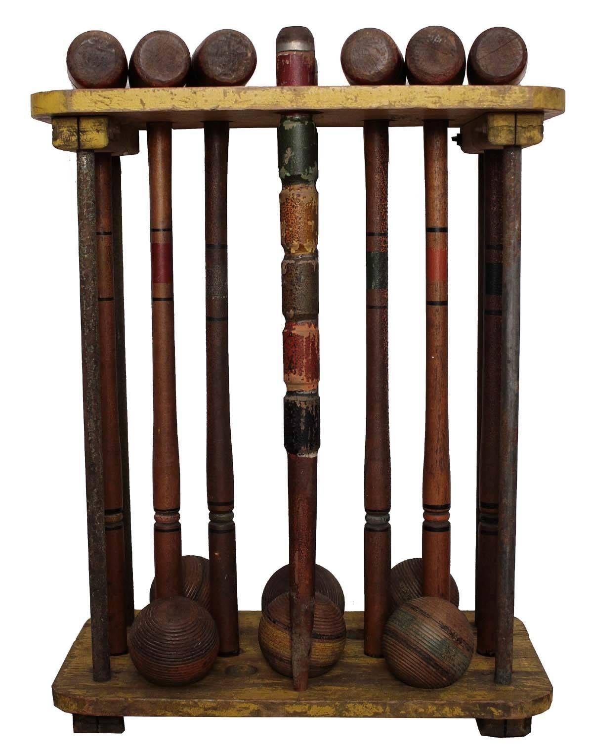 A complete antique croquet set. This set has wonderful color and is in great condition. The uprights on the Stand are metal all other components are wood. Mallets are in working order and original.
