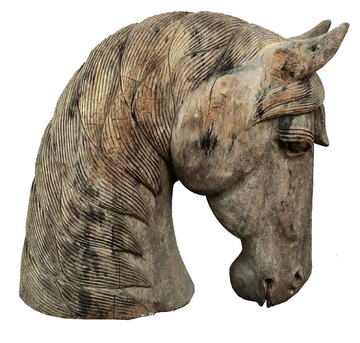 A beautiful and detailed wood horse head. The form is elegant and refined. Carved of solid hardwood, European in style and form he has a wonderful presents. Originally a piece from a carousel it is unsigned or marked.