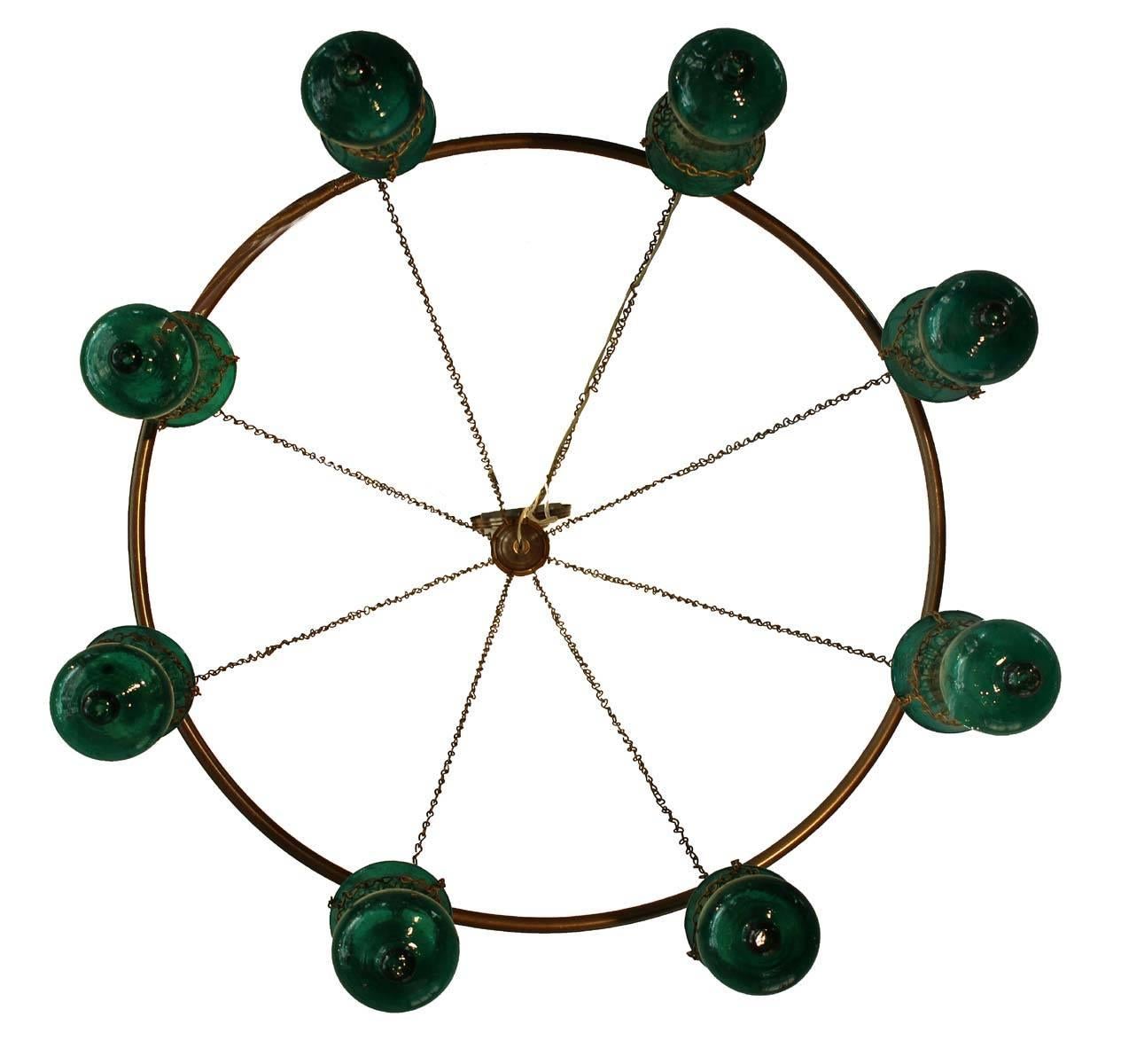 Amazing Egyptian glass chandelier. Eight jar large handblown green glass with a brushed brass ring and chain. Amazing look and can be custom-made in multiple sizes and colors. In the world of original lighting you will not find many options of this
