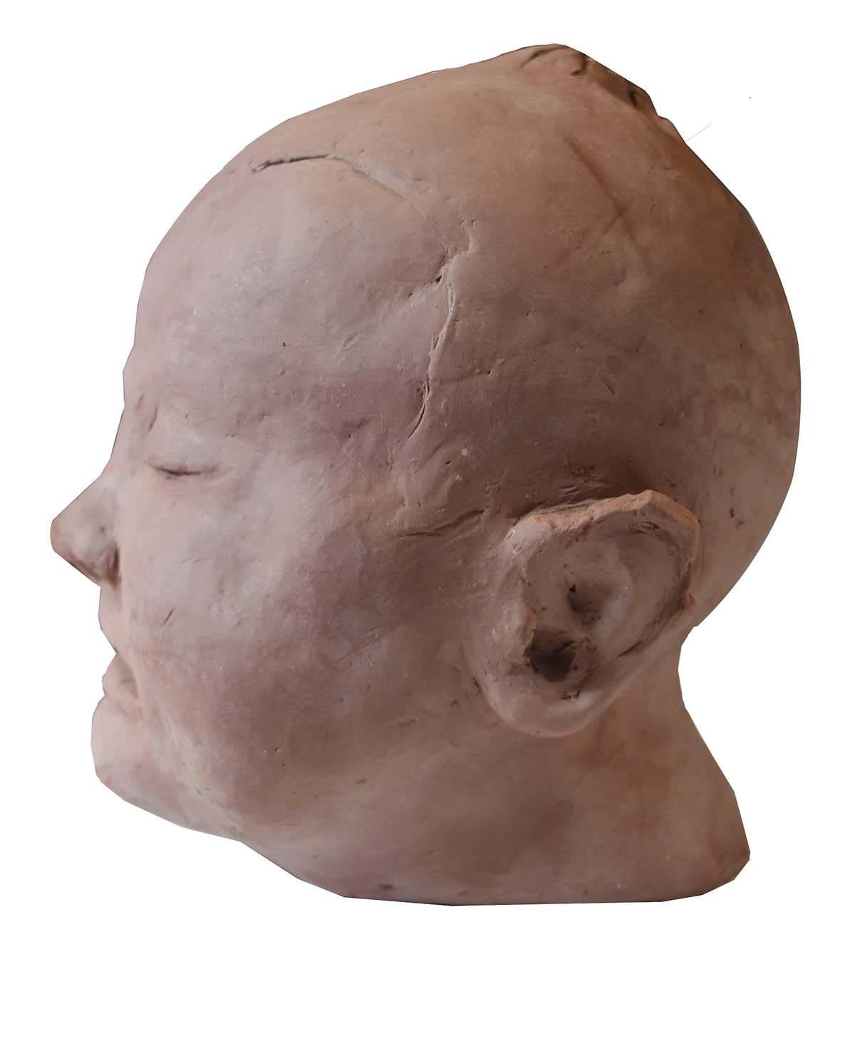 A wonderful sculpture of a sleeping baby's face or head. Done by the sculpture Lee Collette, the image invokes thought and is well done. Originally a commissioned piece it was not completed leaving a wonderful Primitive feel.