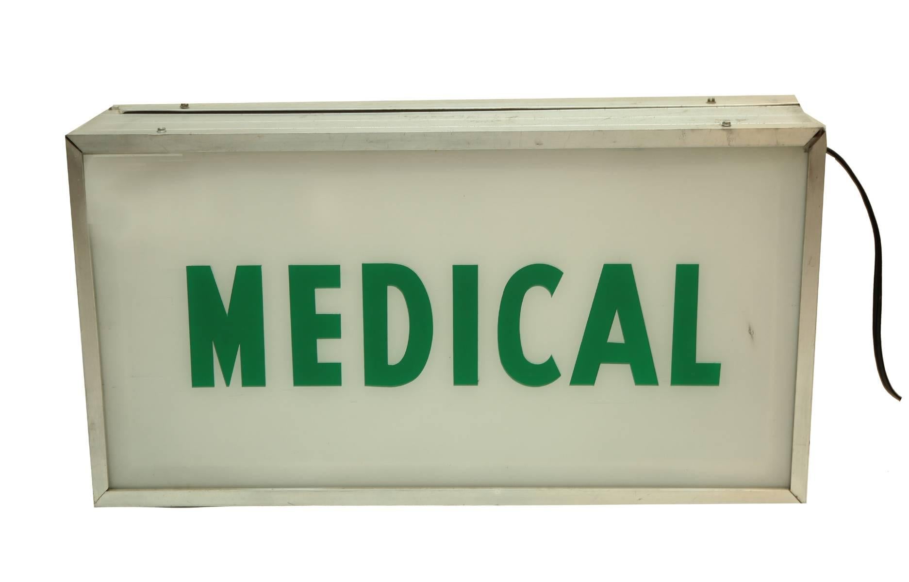 A vintage light box with the words Medical on each side. Lights up, in working order standard plug and cord.