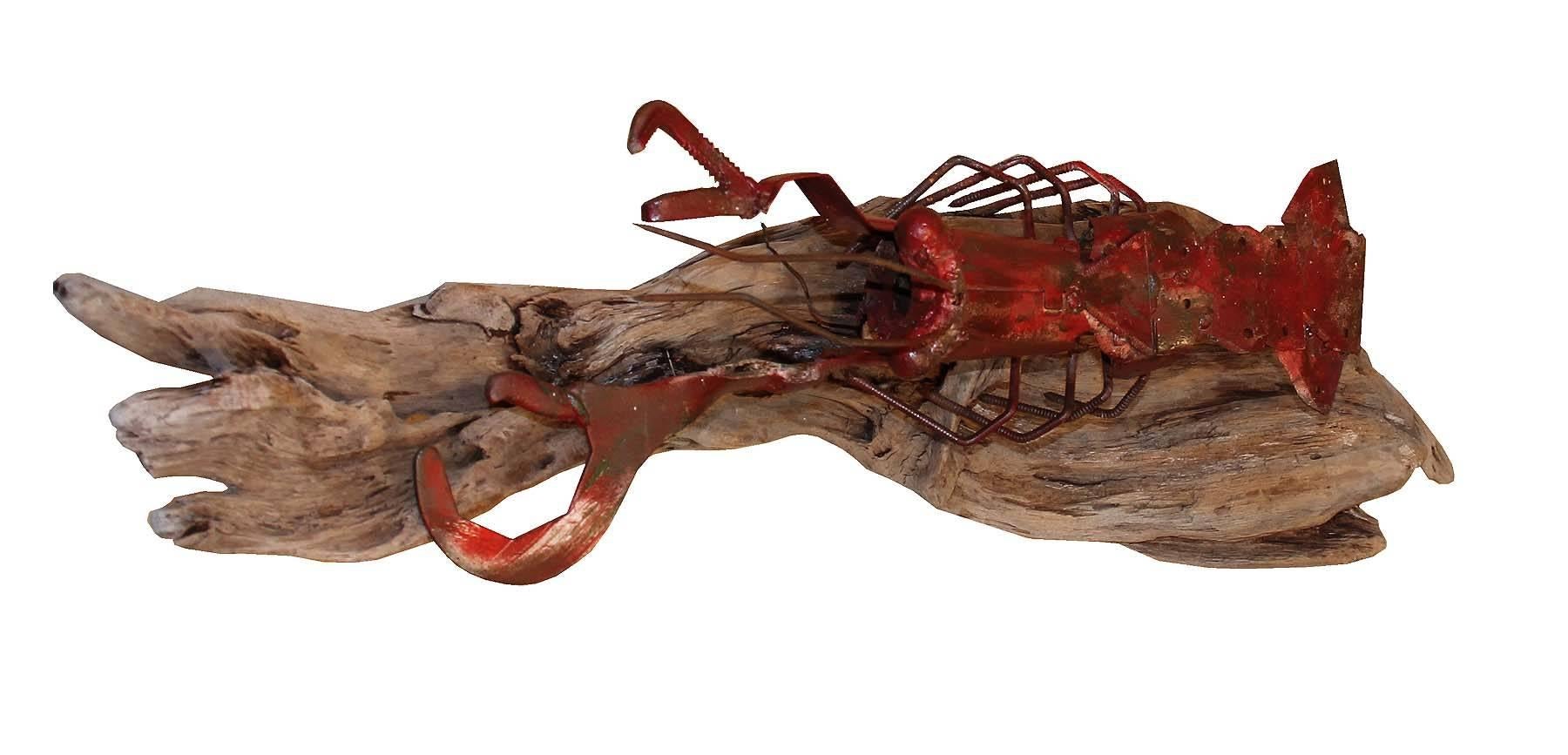 A wonderful piece of Folk Art. The lobster is made from steel wrenches, screws and steel trim. A unique item mounted on a beautiful chunk of driftwood that balances the hard angles of the sculpture with a the soft natural grain flow of the bleached