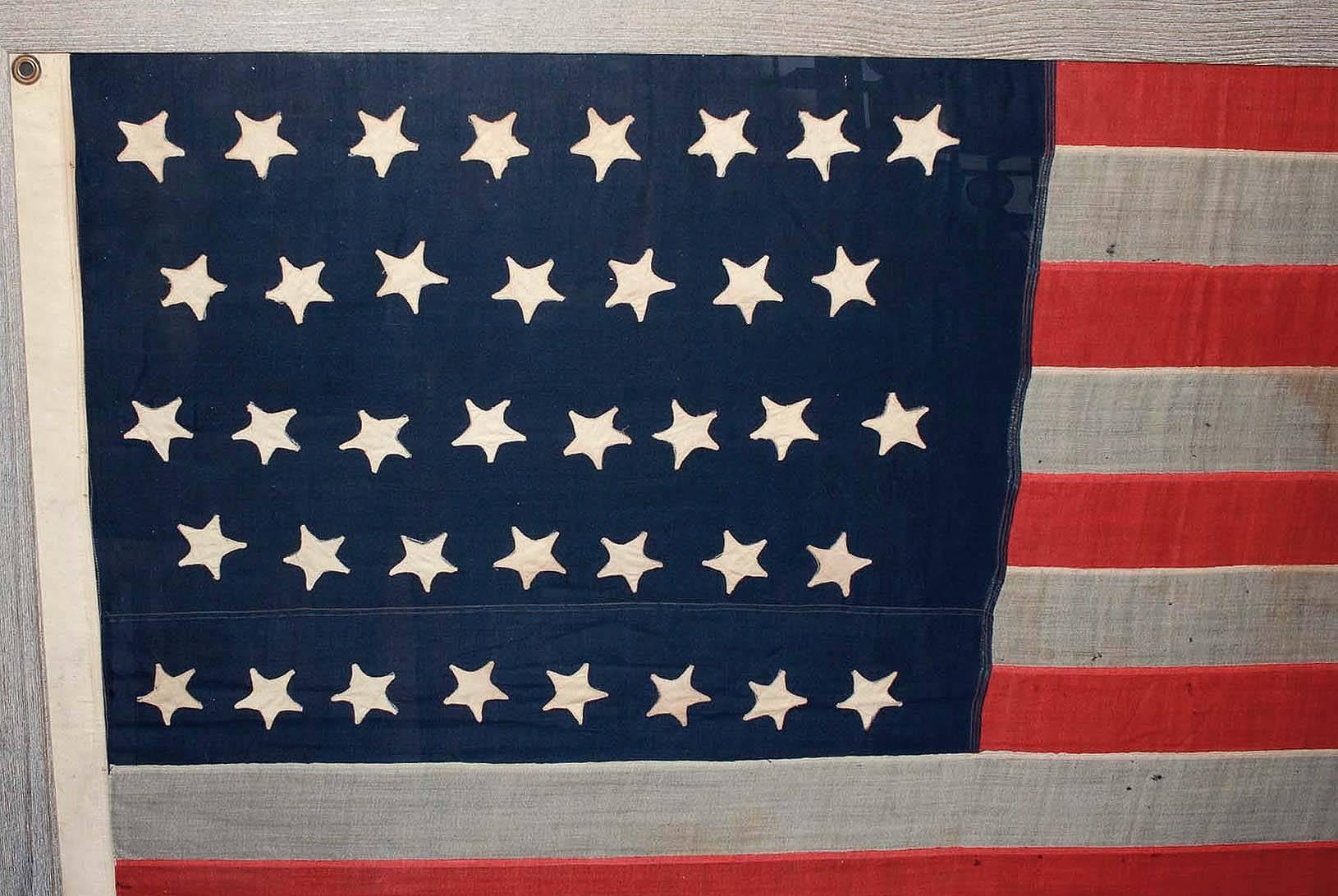 This flag became the Official United States flag on July 4th, 1877. A star was added for the admission of Colorado (August 1st 1876) and was to last for 13 years. Handmade of linen, the stars are all hand-cut and sewn onto the linen. This flag is a