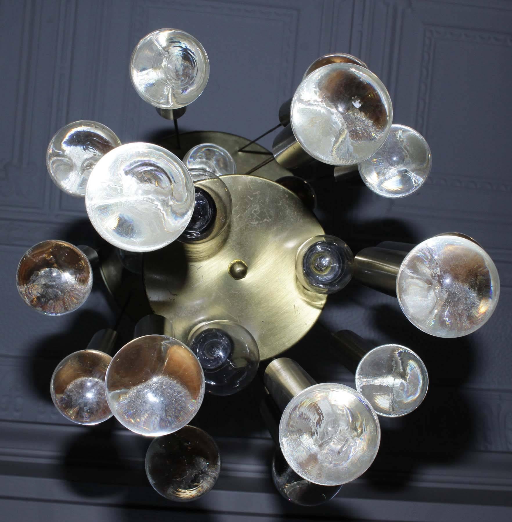 The slim lines of this chandelier by Gaetano Sciolari gives off fantastic light, the light bounces off each of the 24 individual glass balls to create a large spectrum of light. This chandelier was produced in Italy during the 1960s. The Chandelier