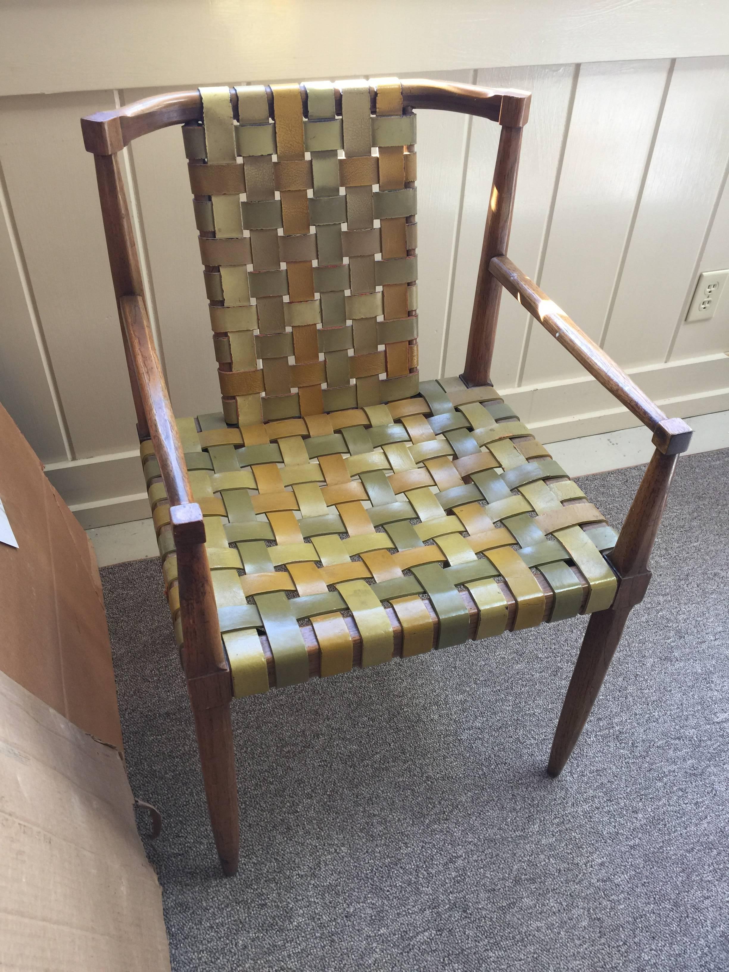 This chair has mustard yellow and sage green leather straps over a beechwood frame and the original patent pending label on the bottom. In fine condition.