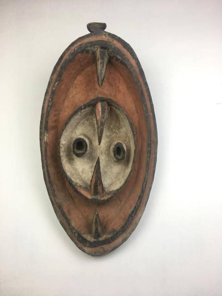 A riveting Hunstein Mountain Garra mask from Papua New Guinea.  This mask is from the estate/collection of Gore Vidal and is from the early to md 20th century. The mask is carved and made of solid wood and decorated with natural, red, orange, black