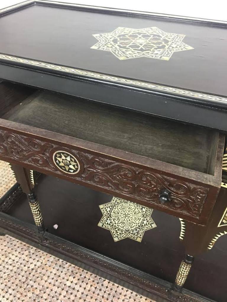 From the estate of the Gore Vidal this 19th century mother-of-pearl inlaid Syrian table shows incredible workmanship and detail: Arabesque supports, Syrian star and skirt carving. In good vintage condition.