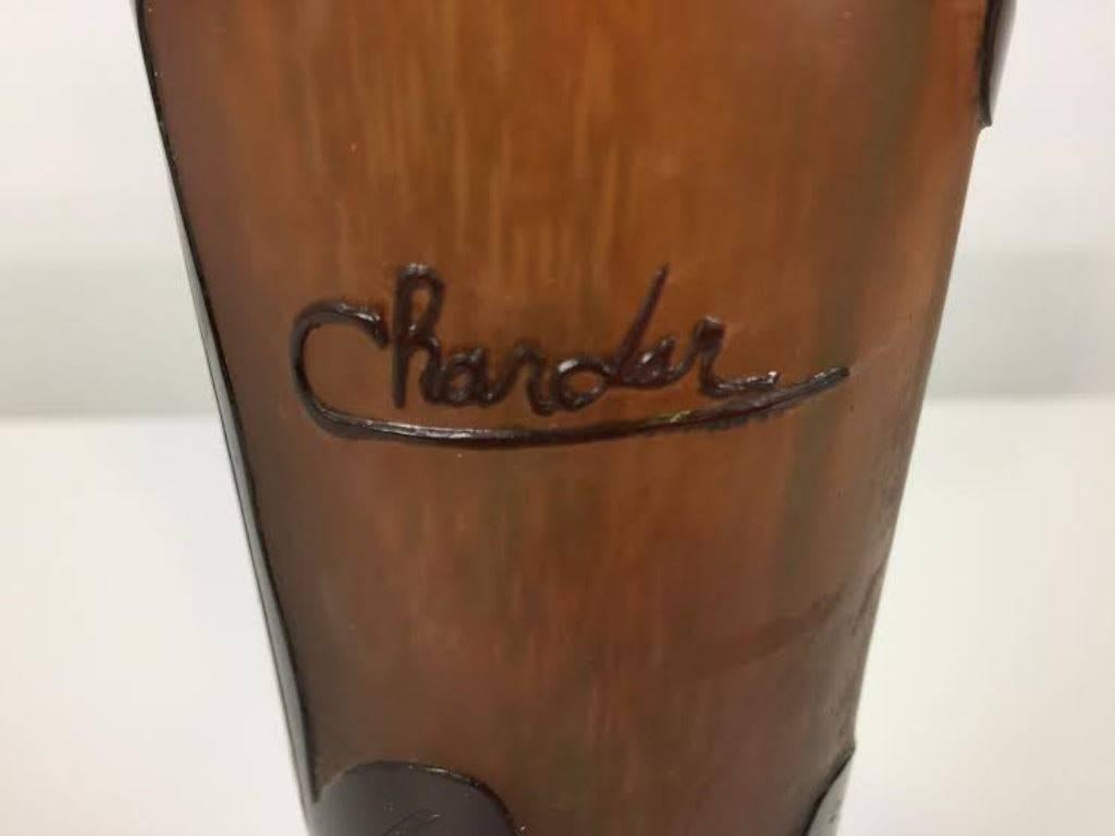 A gorgeously designed and decorated Art Deco glass vase by Charder. The vase has multi-layered glass with acid-etched detail and sits atop a small pedestal base. Signed 