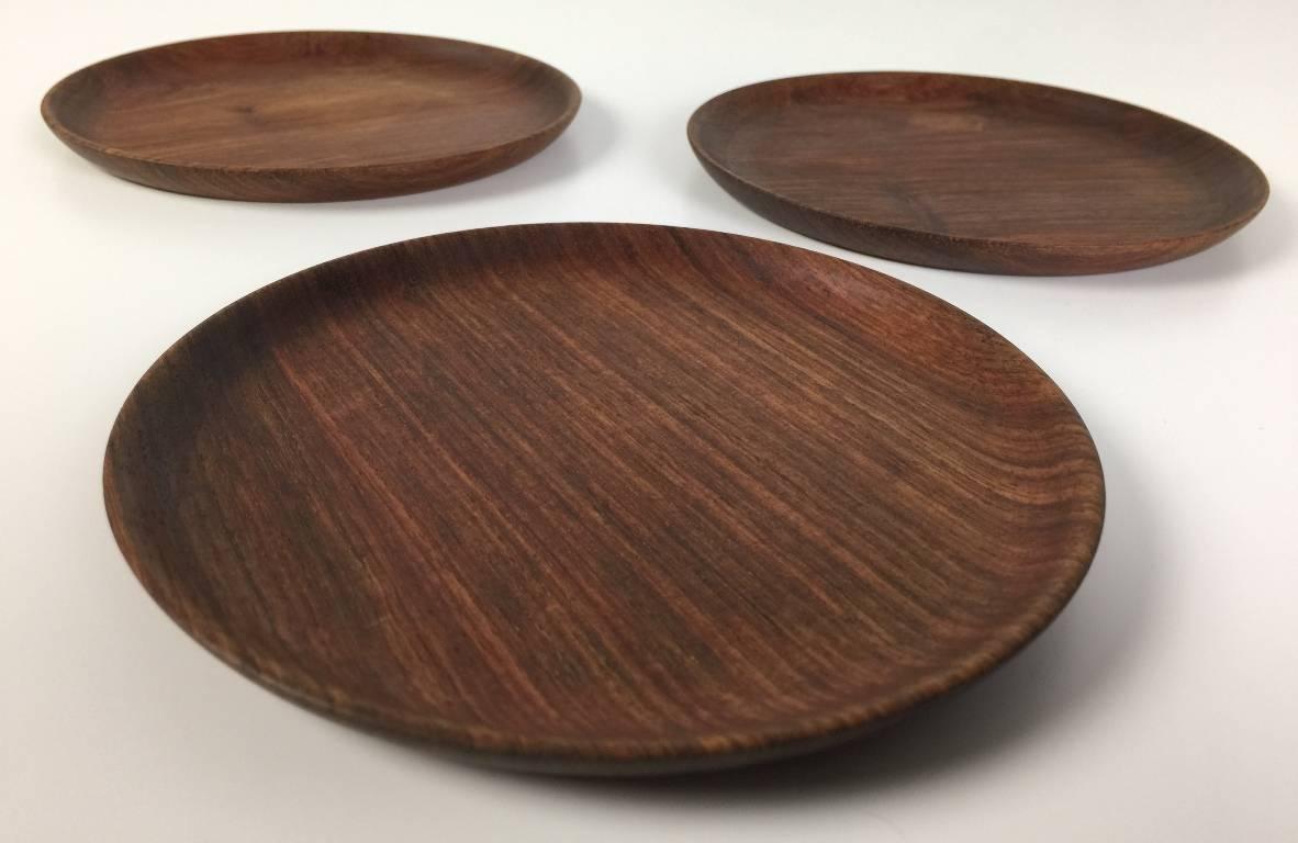 A set of three beautiful, rich colored wood plates by American master wood turner Bob Stocksdale. Signed, dated (1992) and marked 