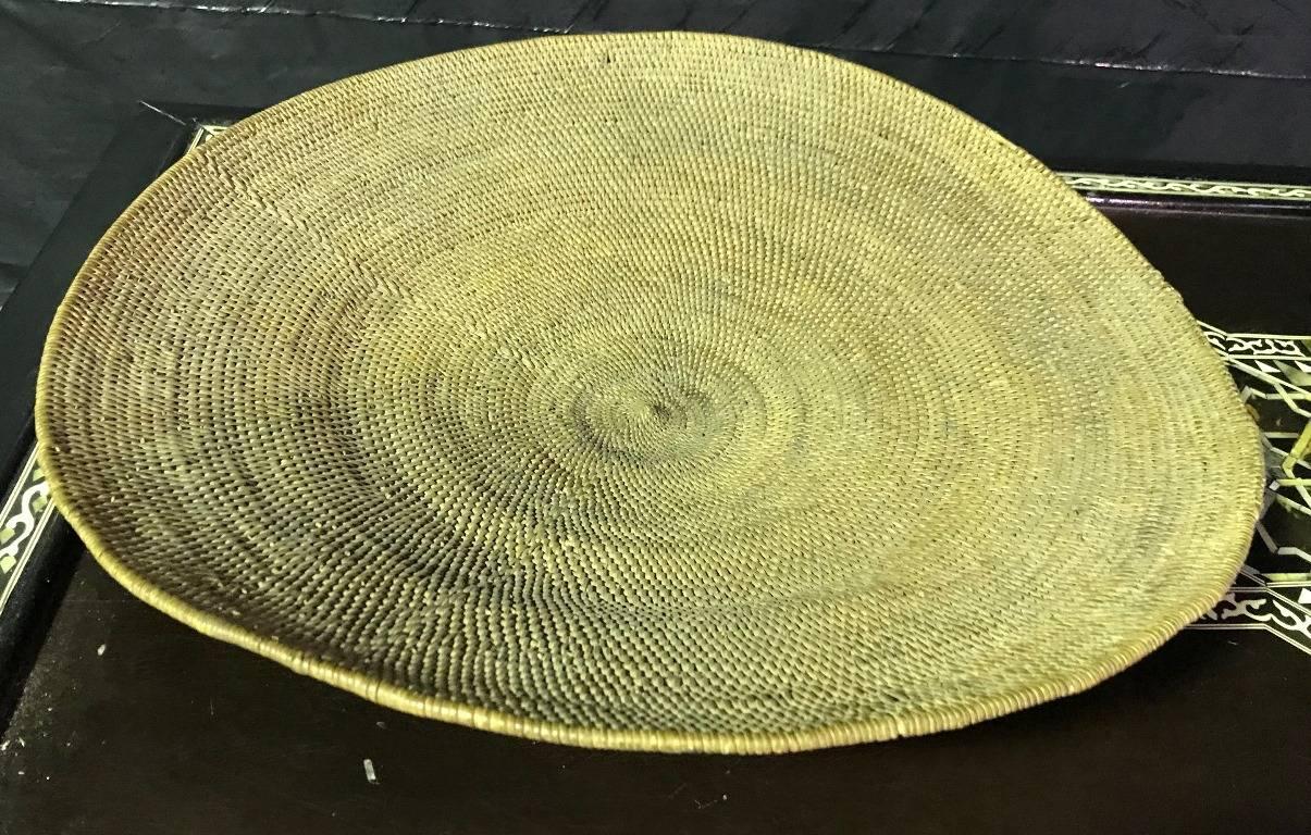 A beautifully and intricately woven Native North American woven tray or basket. Wonderful craftsmanship and detail. We are not sure of what particular tribe this is from but it was acquired from an estate of a large collection of Native American