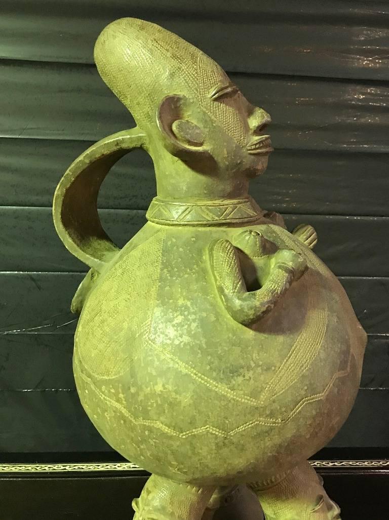 This is a fantastic piece likely made by the Mangetu tribe of the Democratic Republic of the Congo. It is finely detailed and quite large and hefty. These pieces were originally made to collect palm wine but over time has evolved into figurative