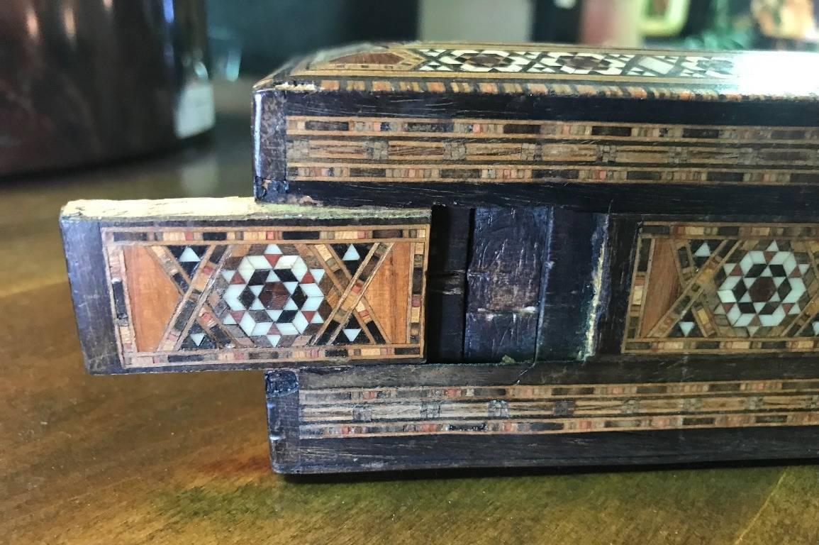 Stunning mosaic design and gorgeous craftsmanship. The box is made of various wood, mother-of-pearl and bone inlays. A genuine work of art with a secret compartment or latch that opens the drawer. Originally made for Maroquinerie of Paris.