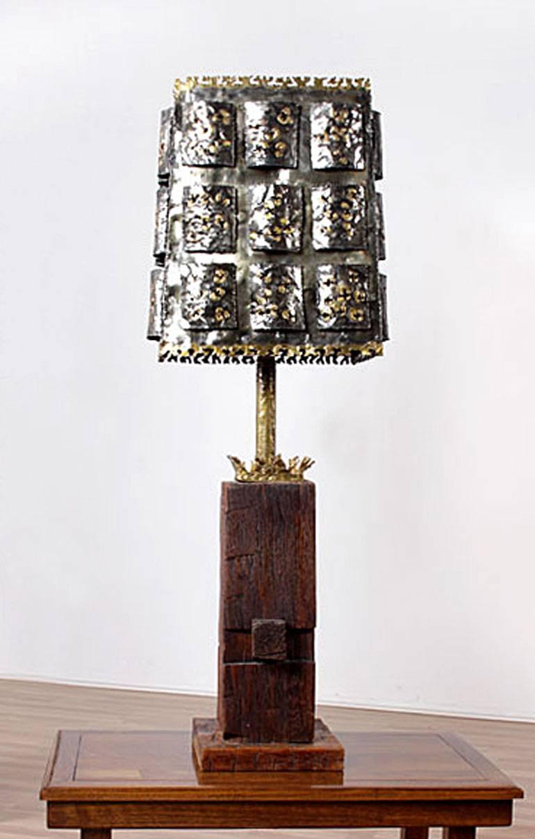 Absolutely stunning midcentury Brutalist table lamp. Body is comprised of a solid block of rough hewn wood. A second block artfully balances within the larger block. Look to the shoulders of the lamp to see a bouquet of ridges that mimic a coral