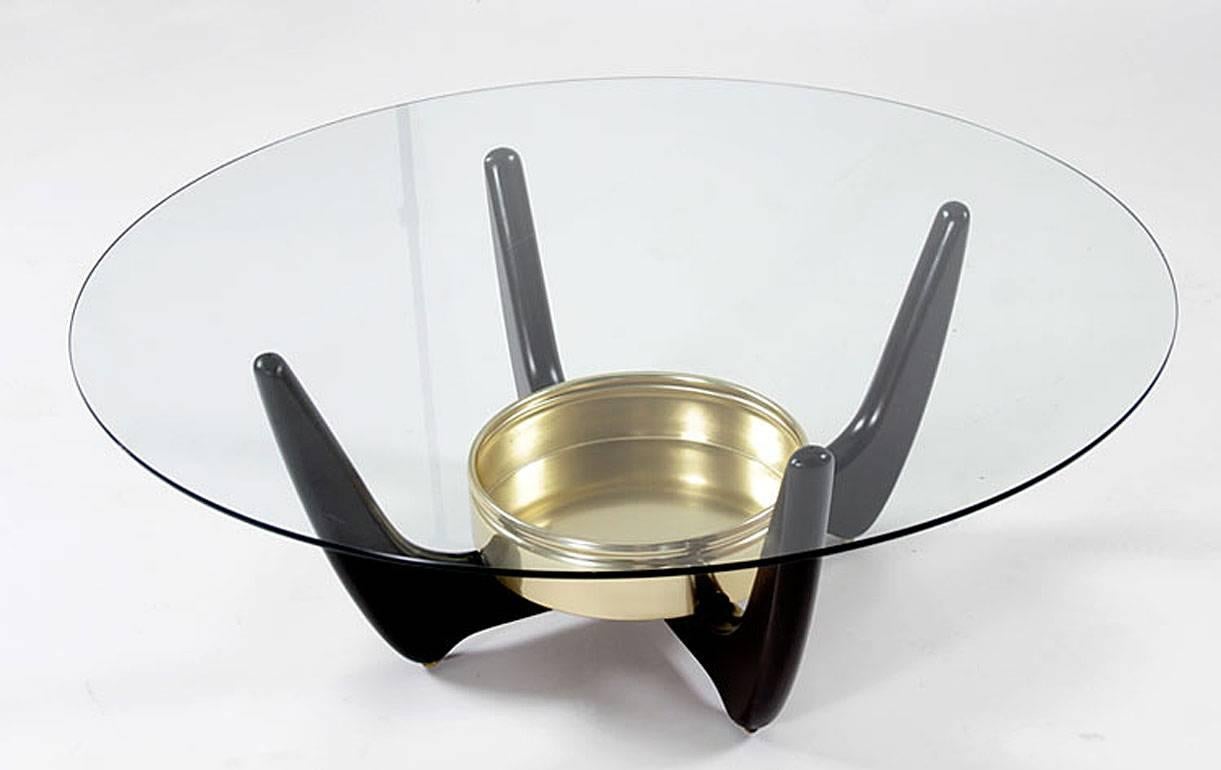 Mid-Century Modern coffee table with gold colored metal planter at center. The amorphic design is reminiscent of works by Adrian Pearsall and Vladimir Kagan. The four pronged solid wood base perfectly balances the circular glass table top. Onlookers