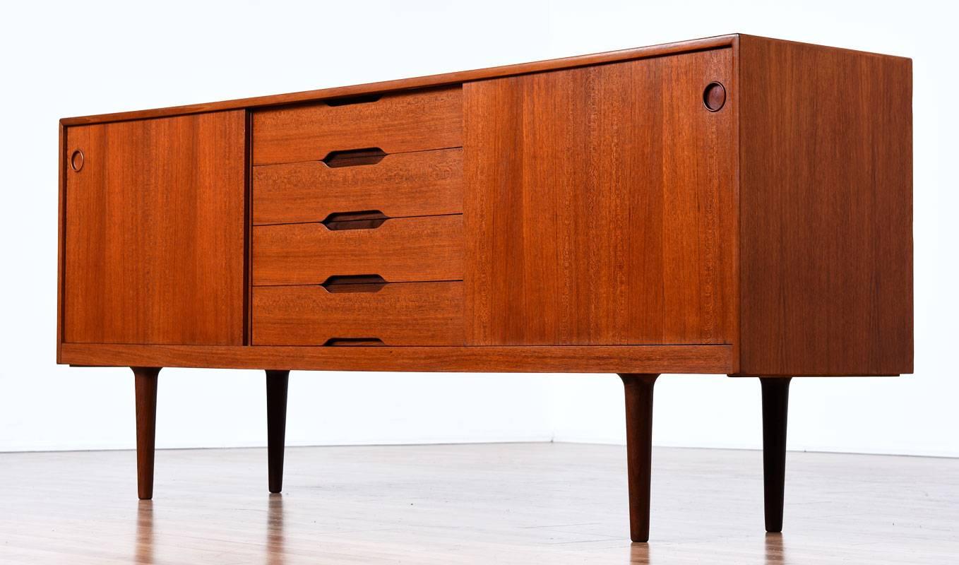 Early Mid-Century Modern Gustav Bahus teak credenza made in Norway. This is an exquisite piece of Scandinavian design. These early items are becoming more difficult to source, making this piece all the more special. The teakwood exhibits that oh so