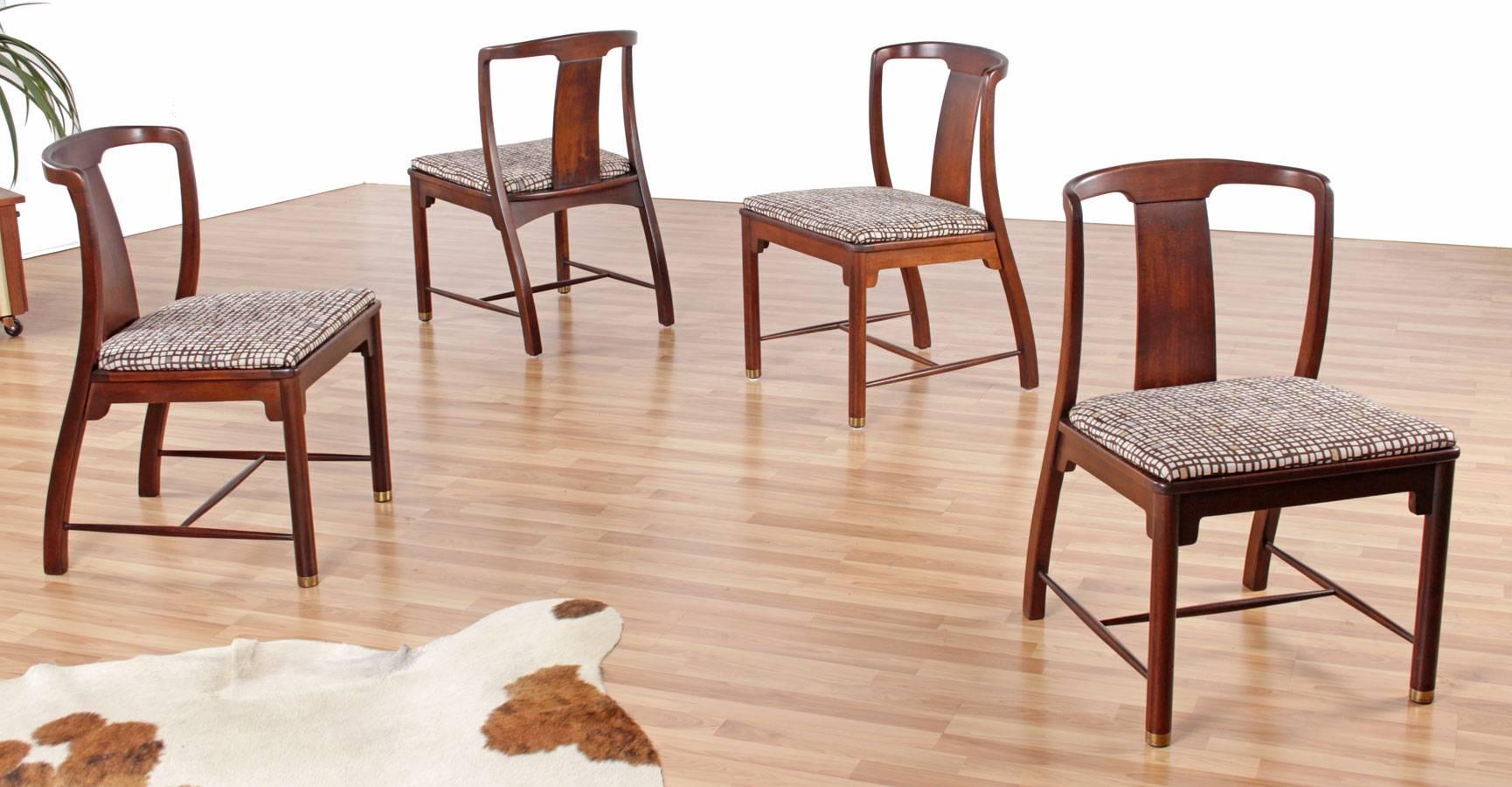 Set of four elegant midcentury chinoiserie dining chairs. The chairs exhibit a form that can best be described as Chinese Minimalist. The jet-set age fascination with exotic cultures is brought to life in this handsome group. The designer chose to