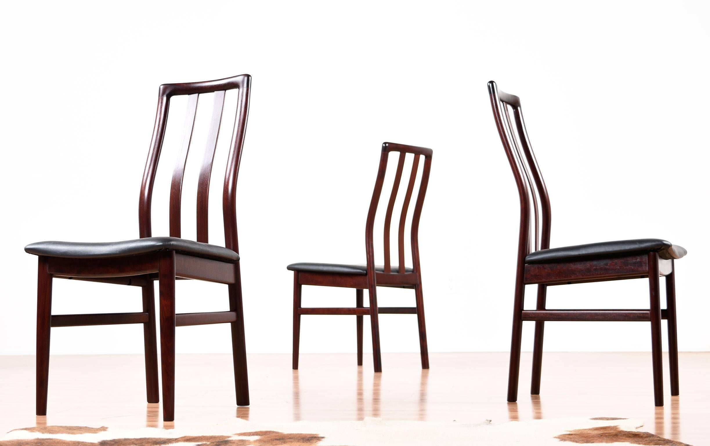 Set of six outstanding vintage, 1980s Scandinavian rosewood dining chairs. These chairs feature ergonomic design with a contoured back to support the natural curve of occupant's body. The rosewood is absolutely stunning with a deep red hue and sleek