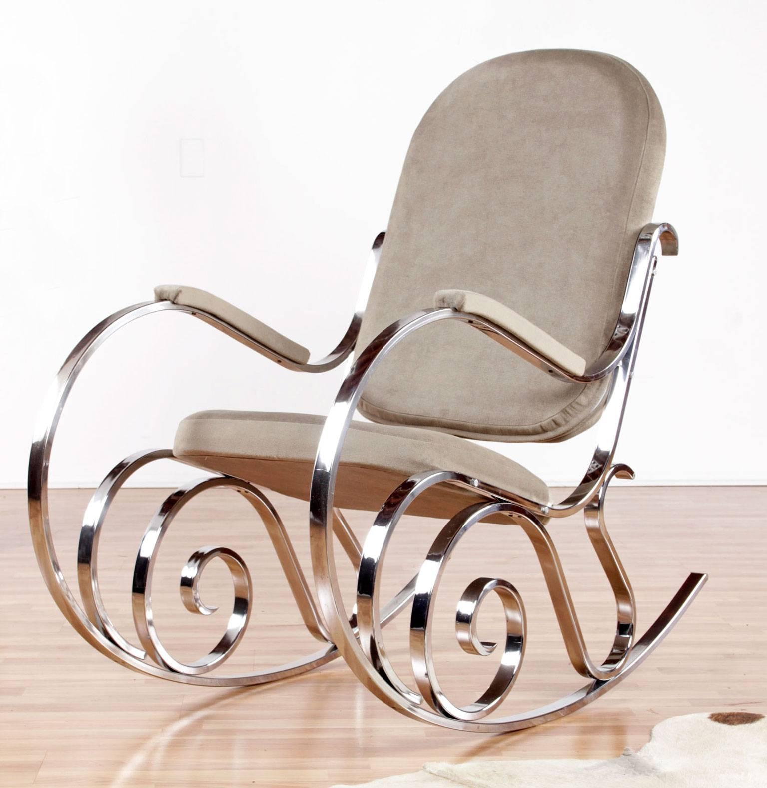 Stunning vintage, 1970s chrome rocking chair designed by Maison Jansen in the 1970s. This Mid-Century Modern style rocker is restored with new taupe colored velour upholstery. The elaborate scroll work of the chrome chair frame gleams as light works