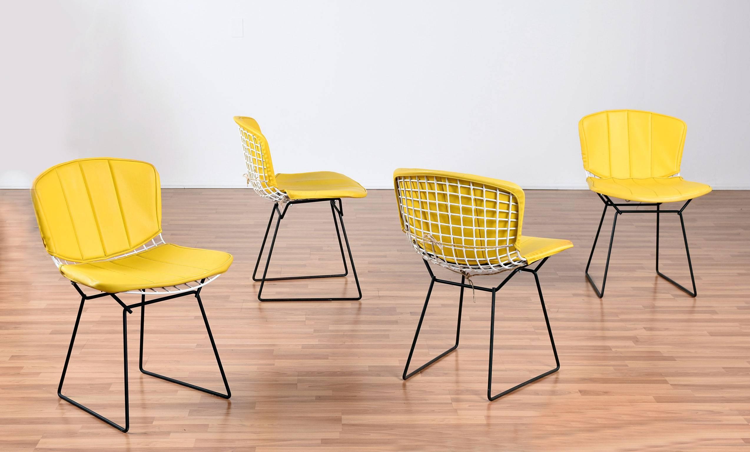 We are pleased to offer this set of four authentic Harry Bertoia wire chairs for Knoll. First designed in the mid-1950s for Knoll. The Bertoia side chair has become one of the iconic classics of the Mid-Century Modern era. This vintage set comes
